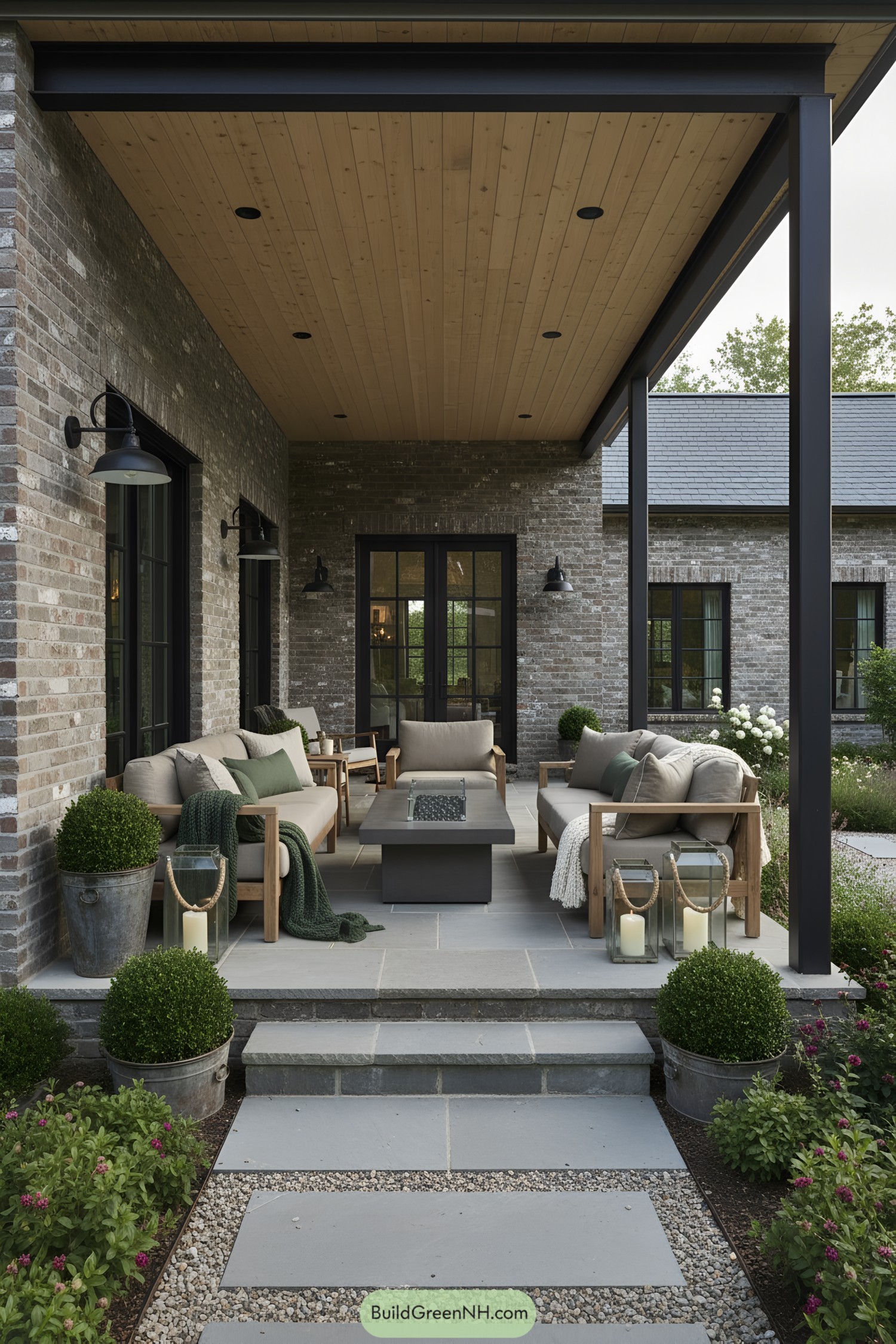 Covered porch with cozy seating and a sleek wooden ceiling