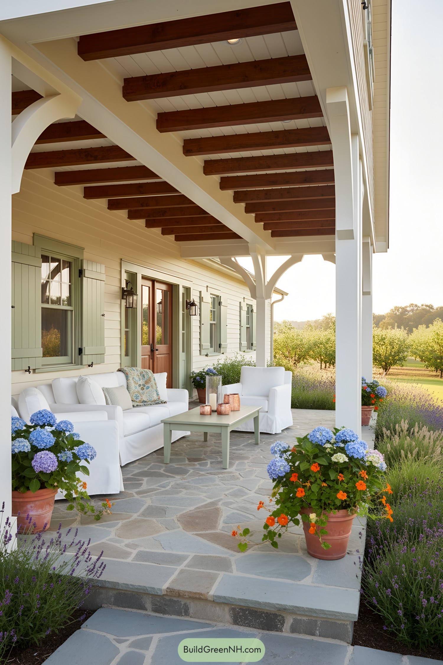 Spacious porch of a modern cottage with comfy seating and colorful flowers