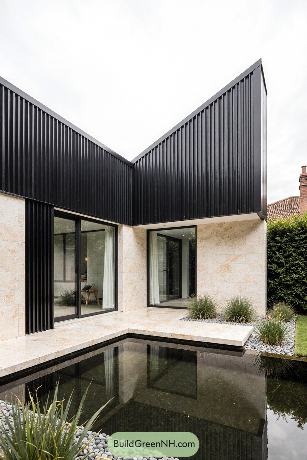 Contemporary house with a pond reflecting its sleek design