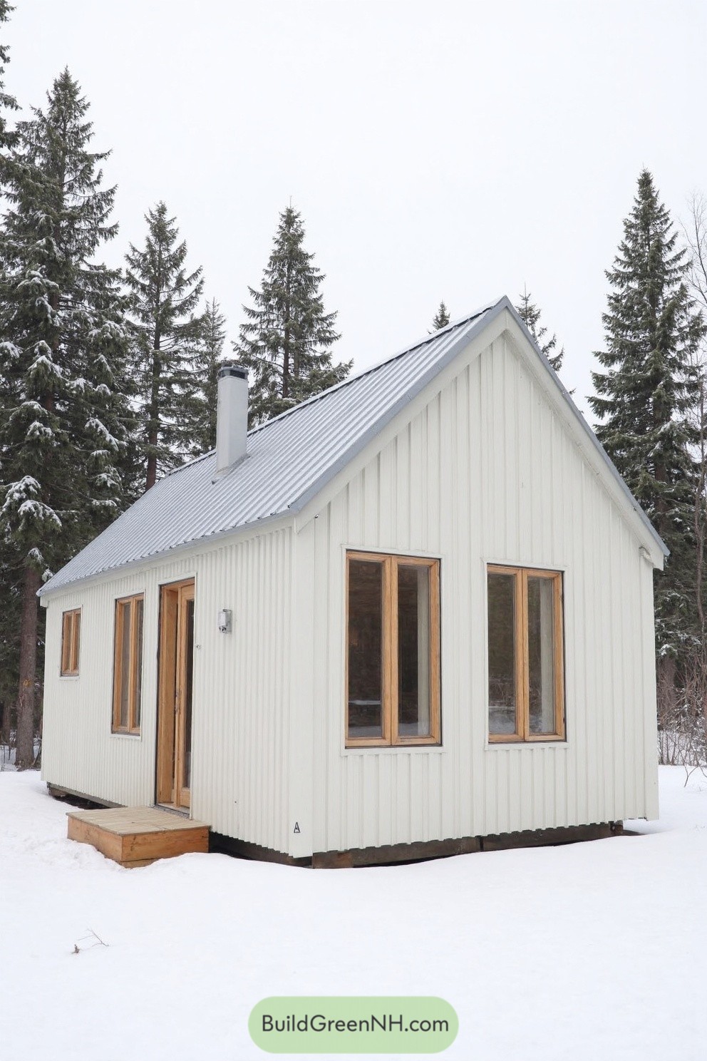 Small cabin amidst snowy landscape