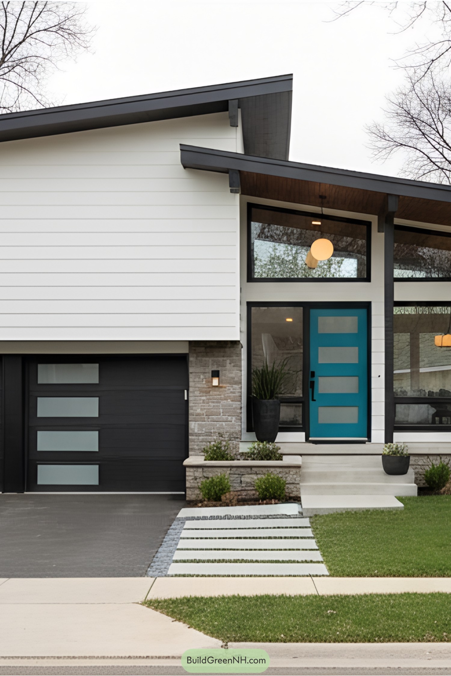 Mid-century modern split-level house with teal door and angular roof