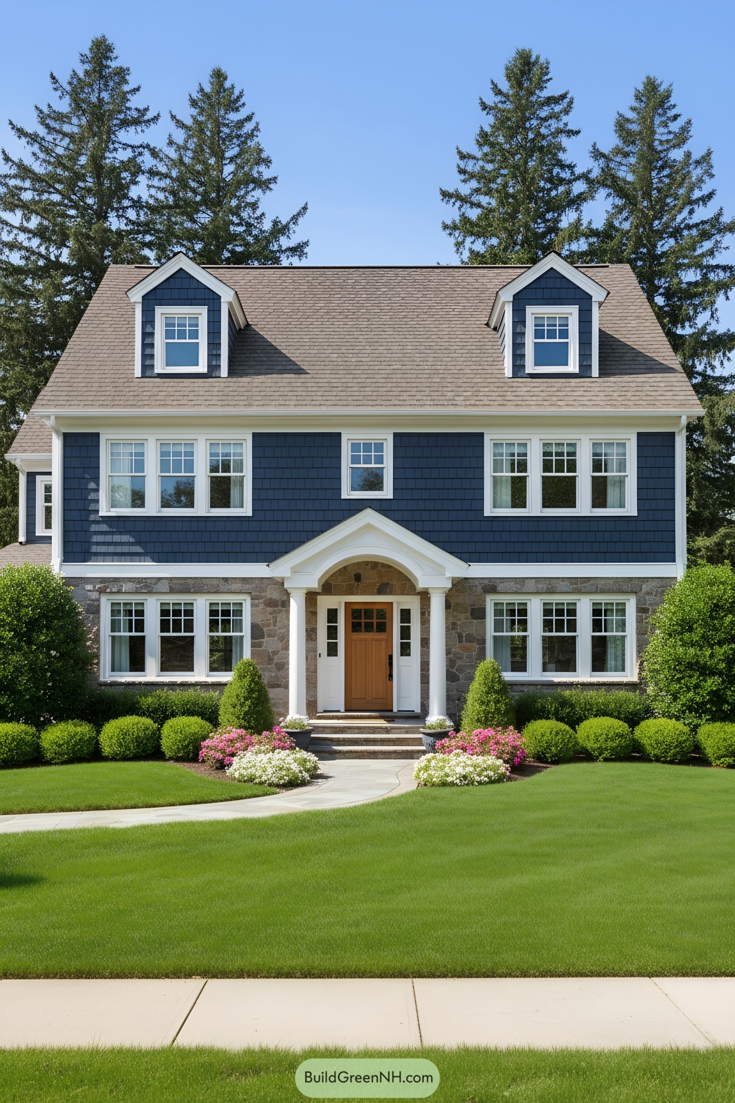 Blue and stone suburban house with neat lawn