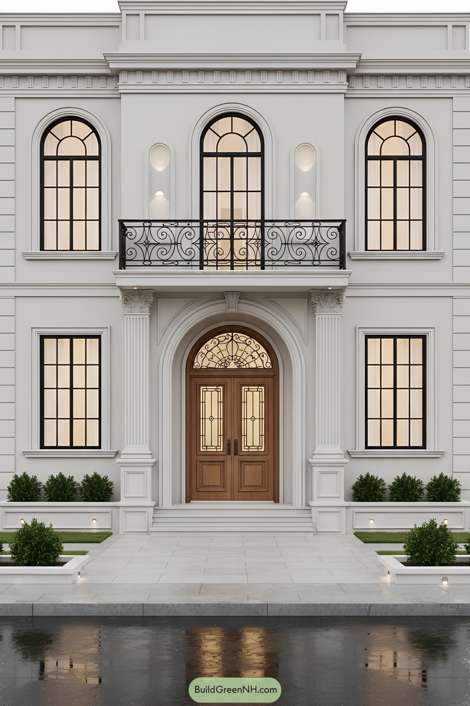Symmetrical white townhouse with arched windows and wrought-iron balcony