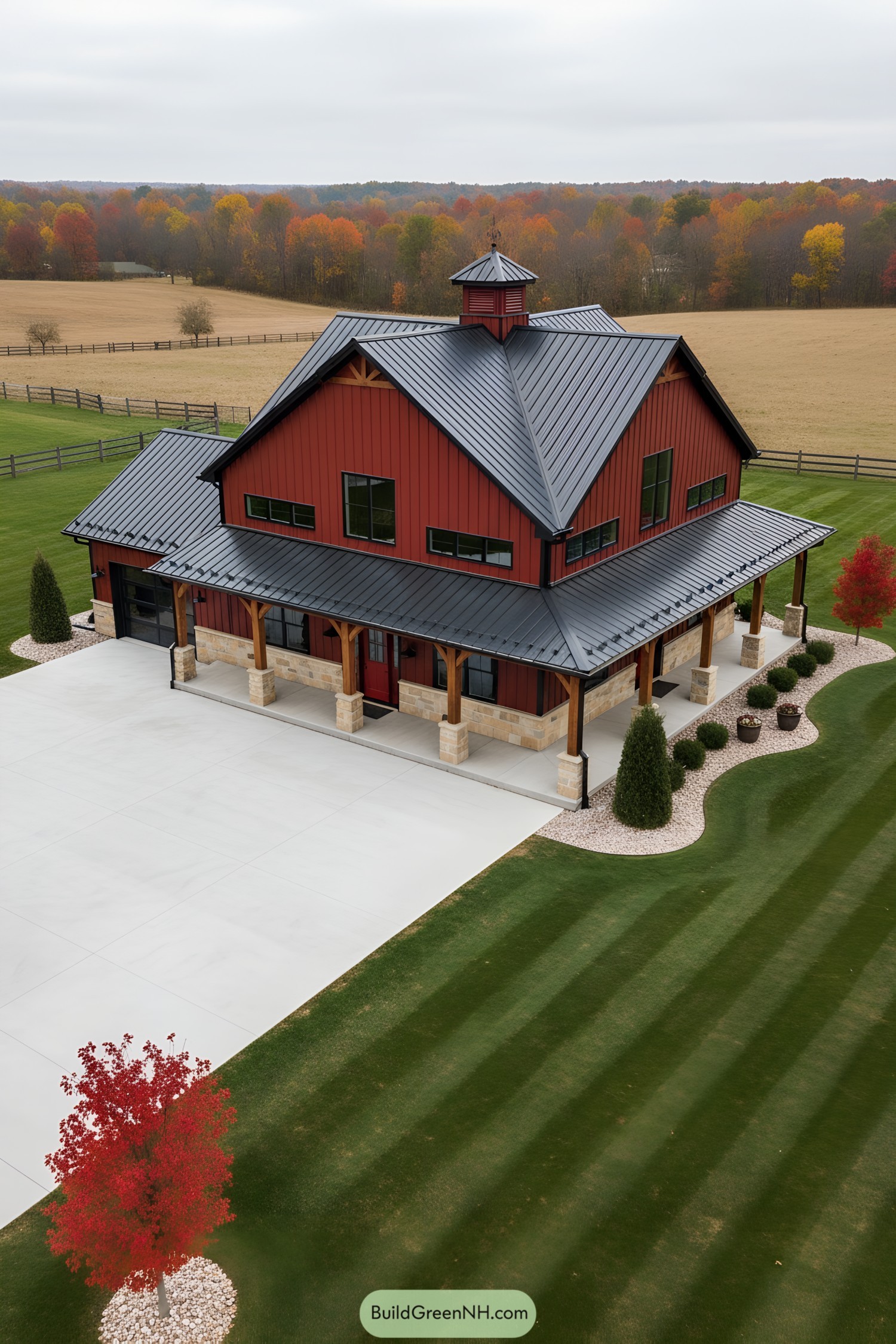 Red metal barn house with black standing-seam roof and wraparound porch