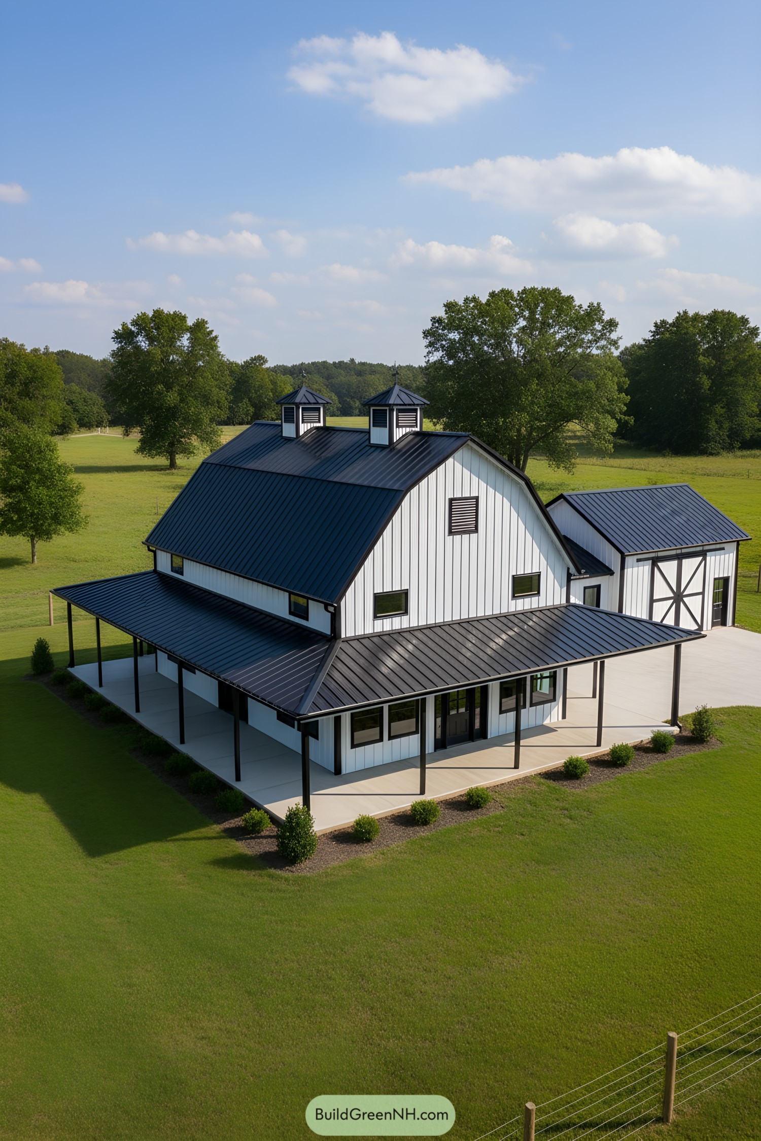 Black-roof white gambrel barn home with wraparound porch
