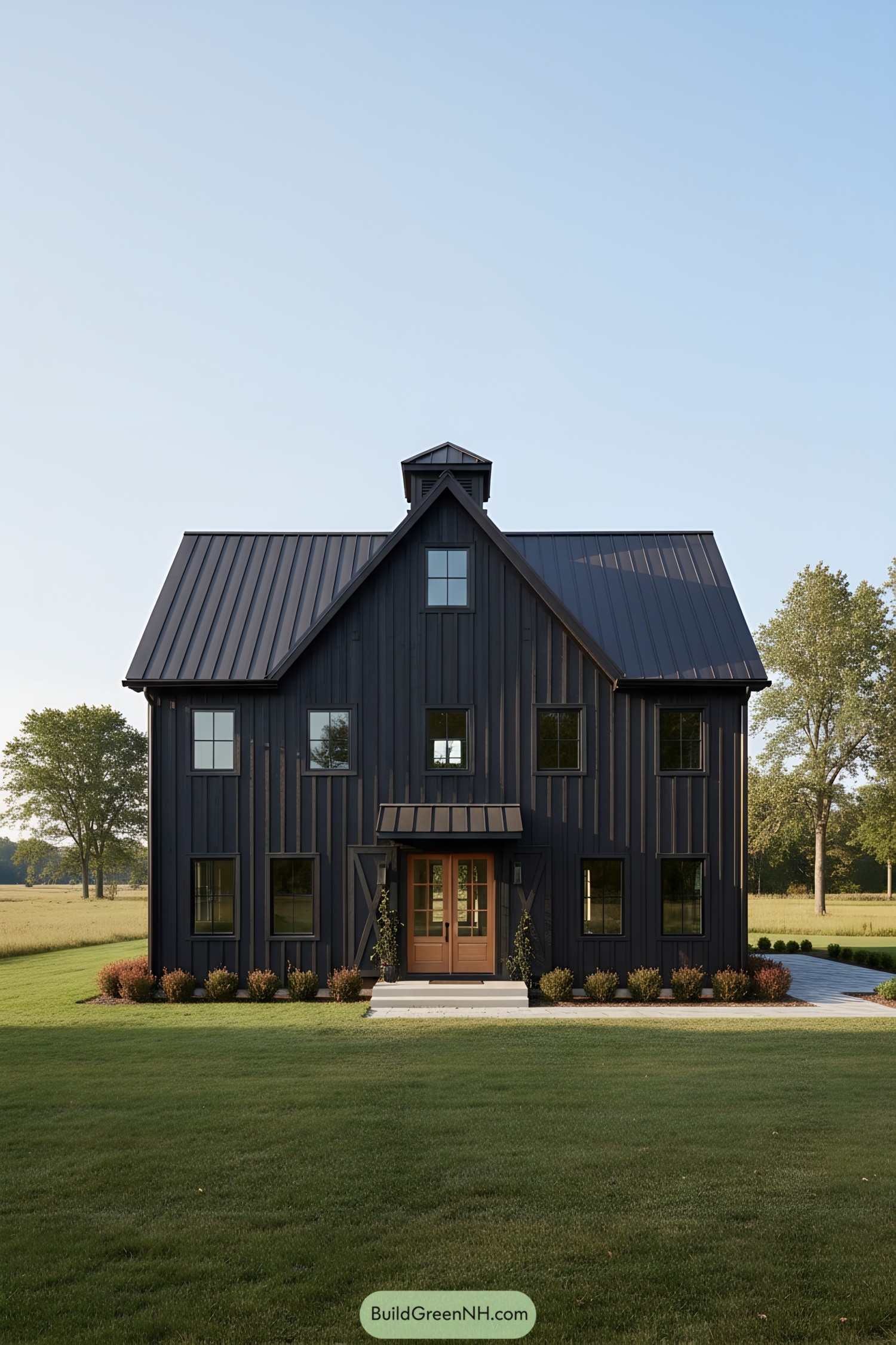 Black metal-clad barn house with warm wood entry