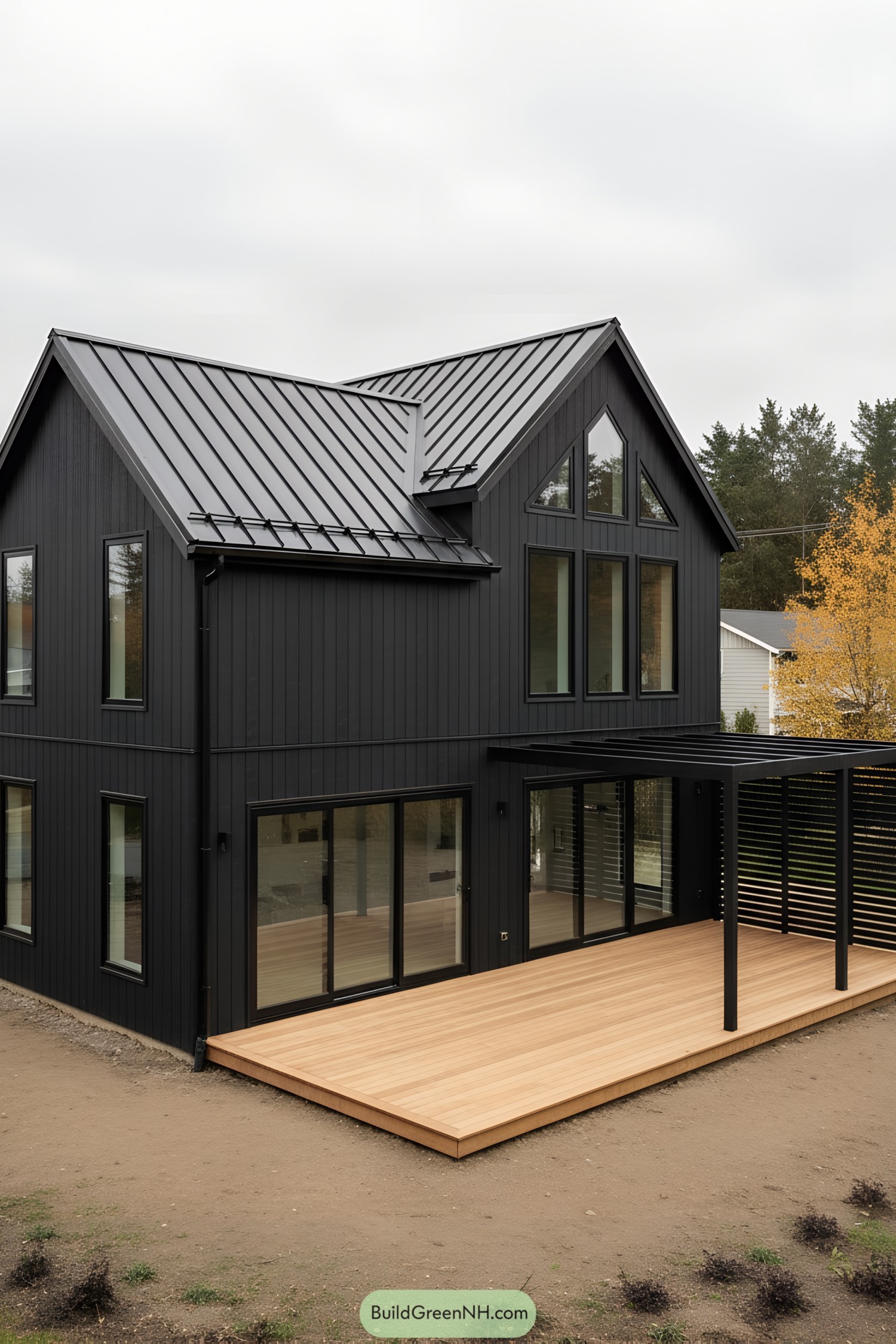 Black-clad modern barn house with metal roof and light wood deck