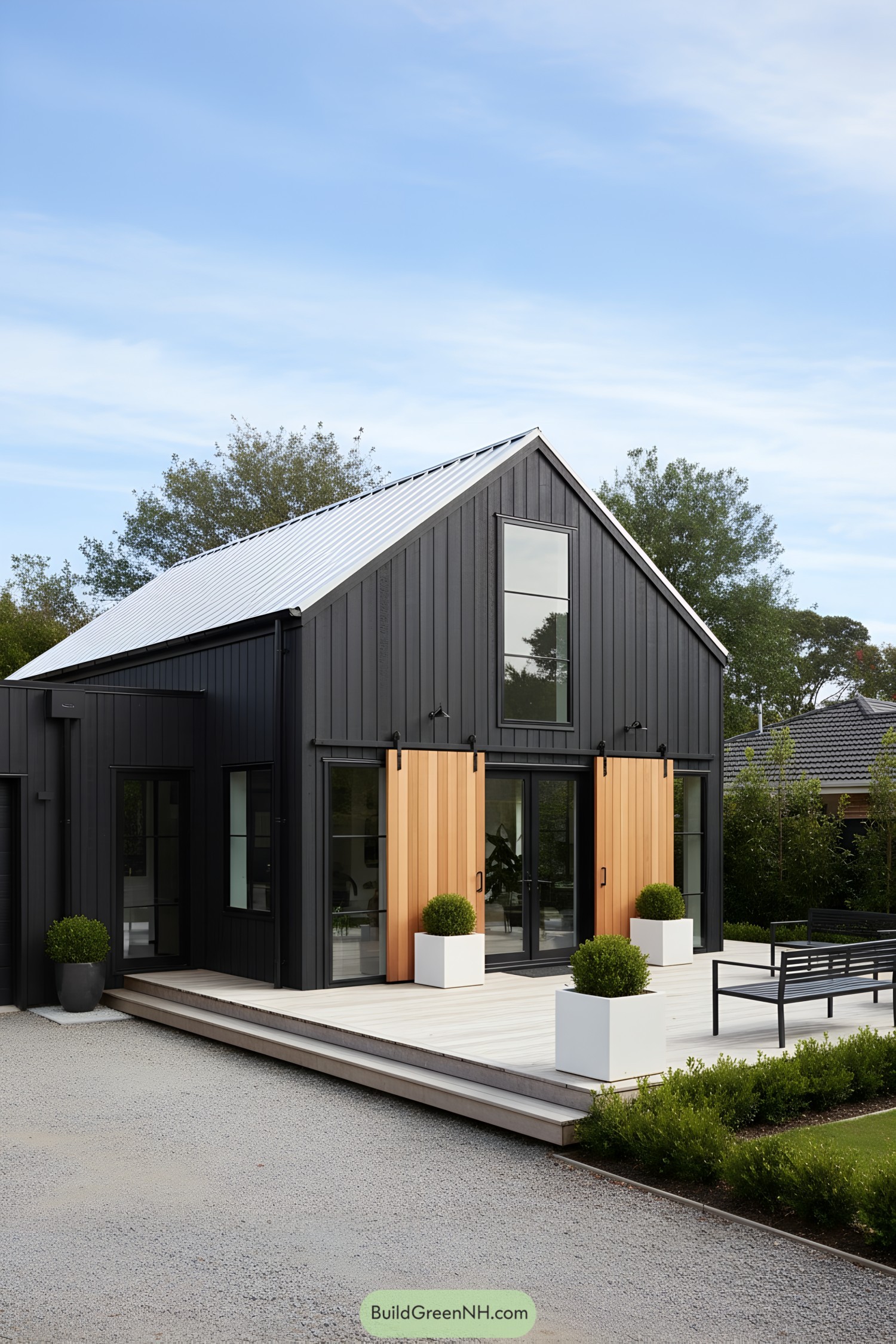 Black barn house with cedar sliding shutters