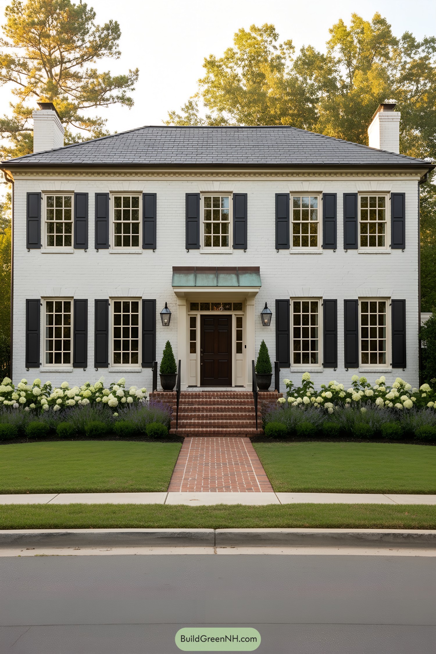 White-painted brick colonial with black shutters and copper-accented entry