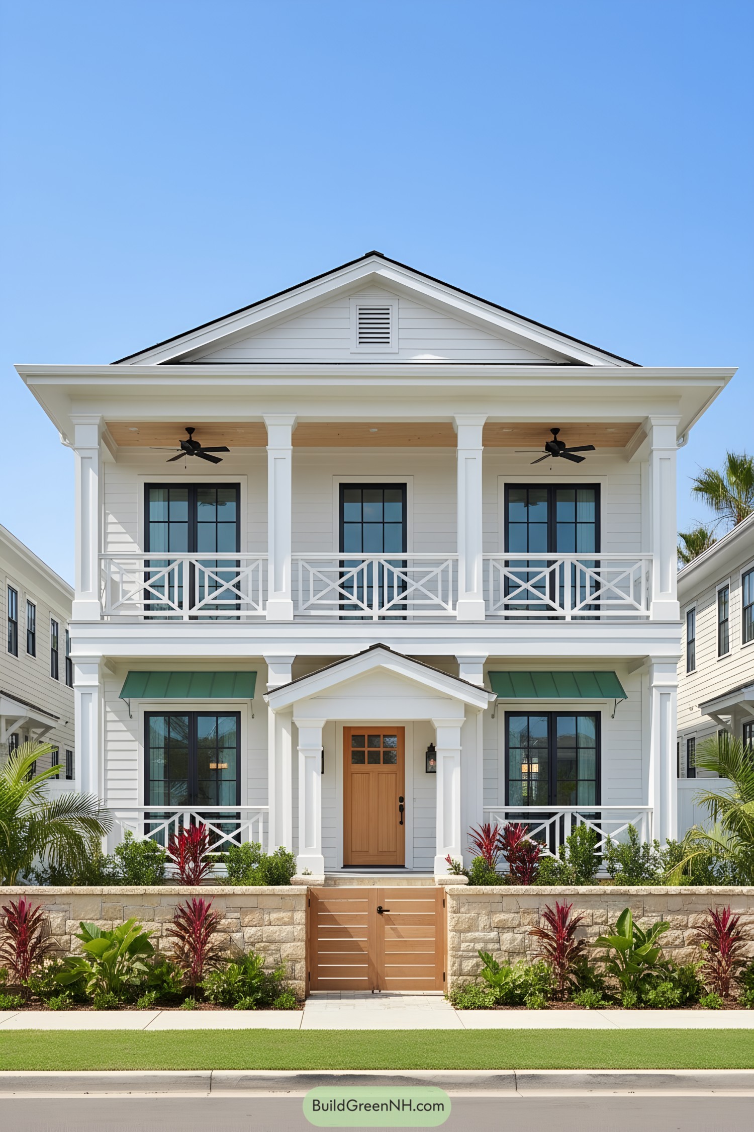 Two-story white colonial house with gabled roof, double porches, and green awnings