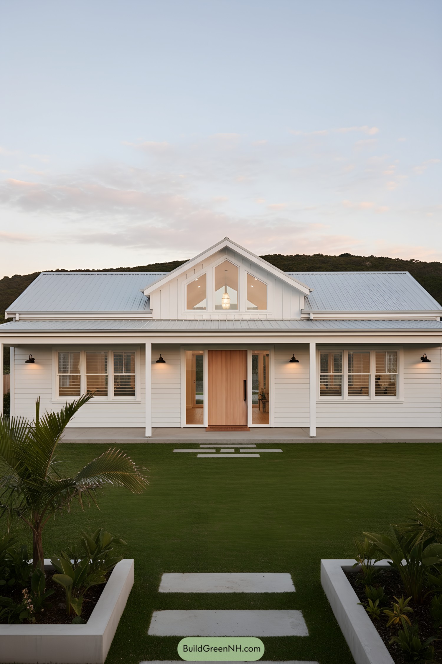 White coastal barn house with metal roof and warm wood door