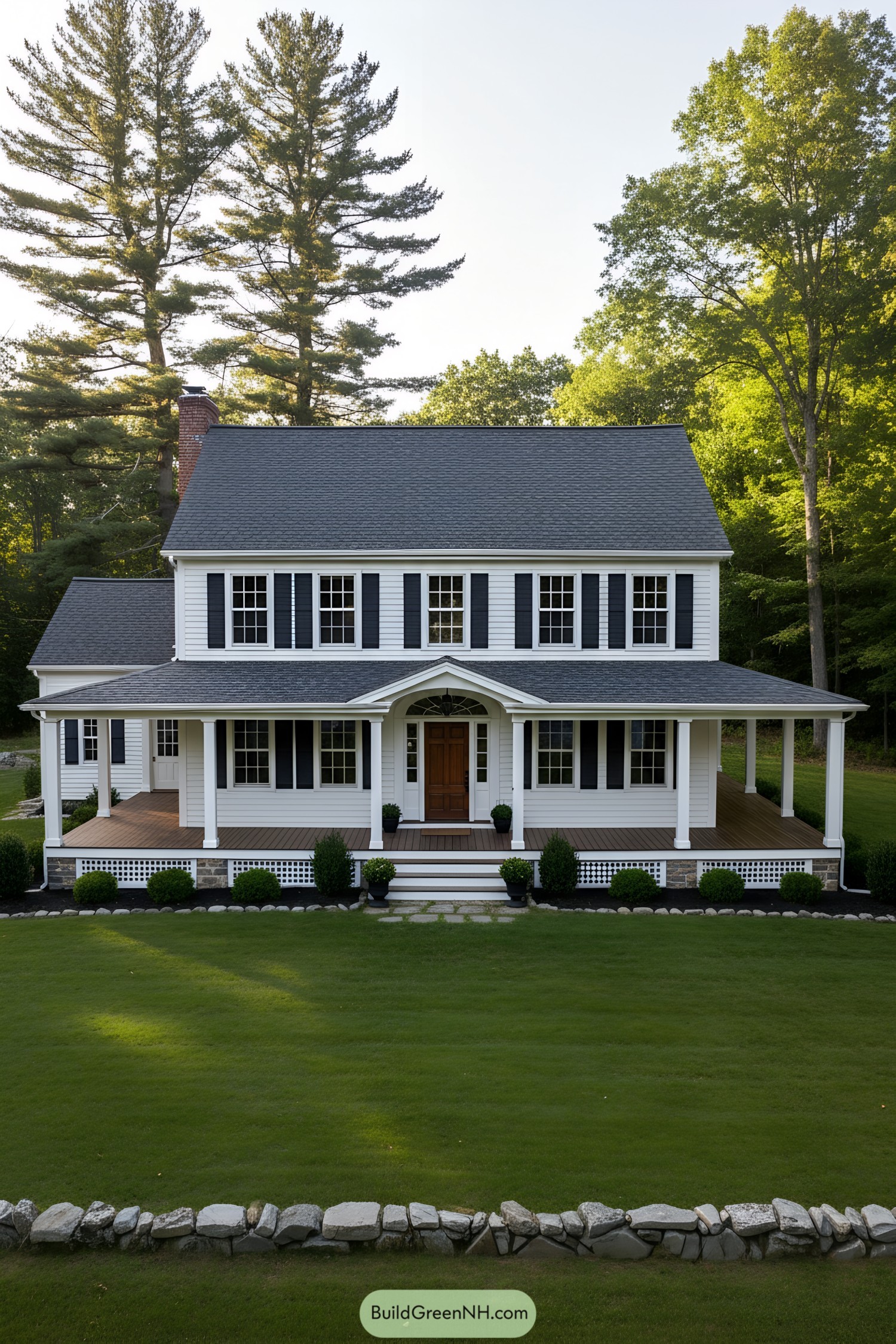 White clapboard farmhouse with black shutters, deep wraparound porch, and fanlight entry