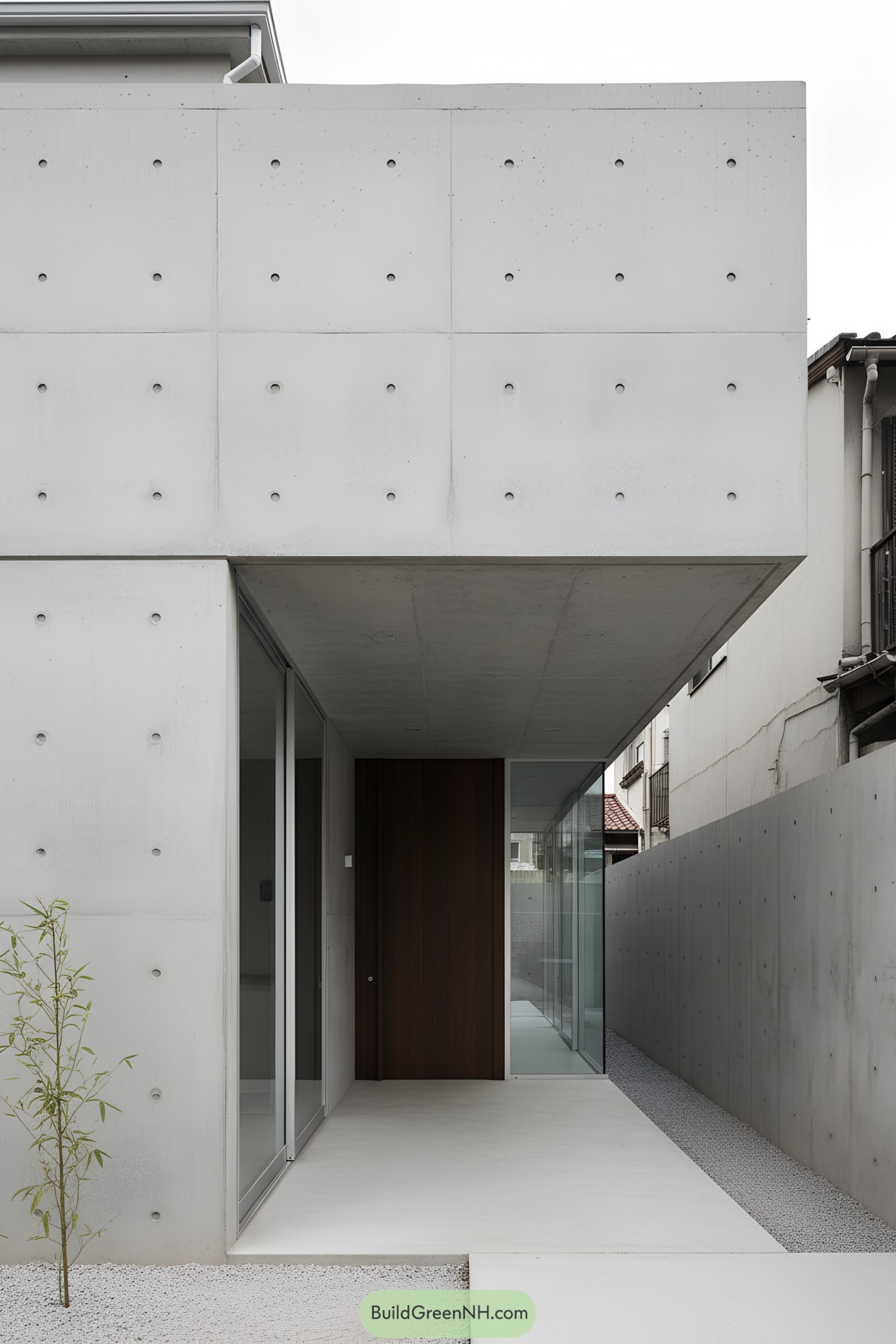 Minimalist concrete courtyard with cantilevered entry