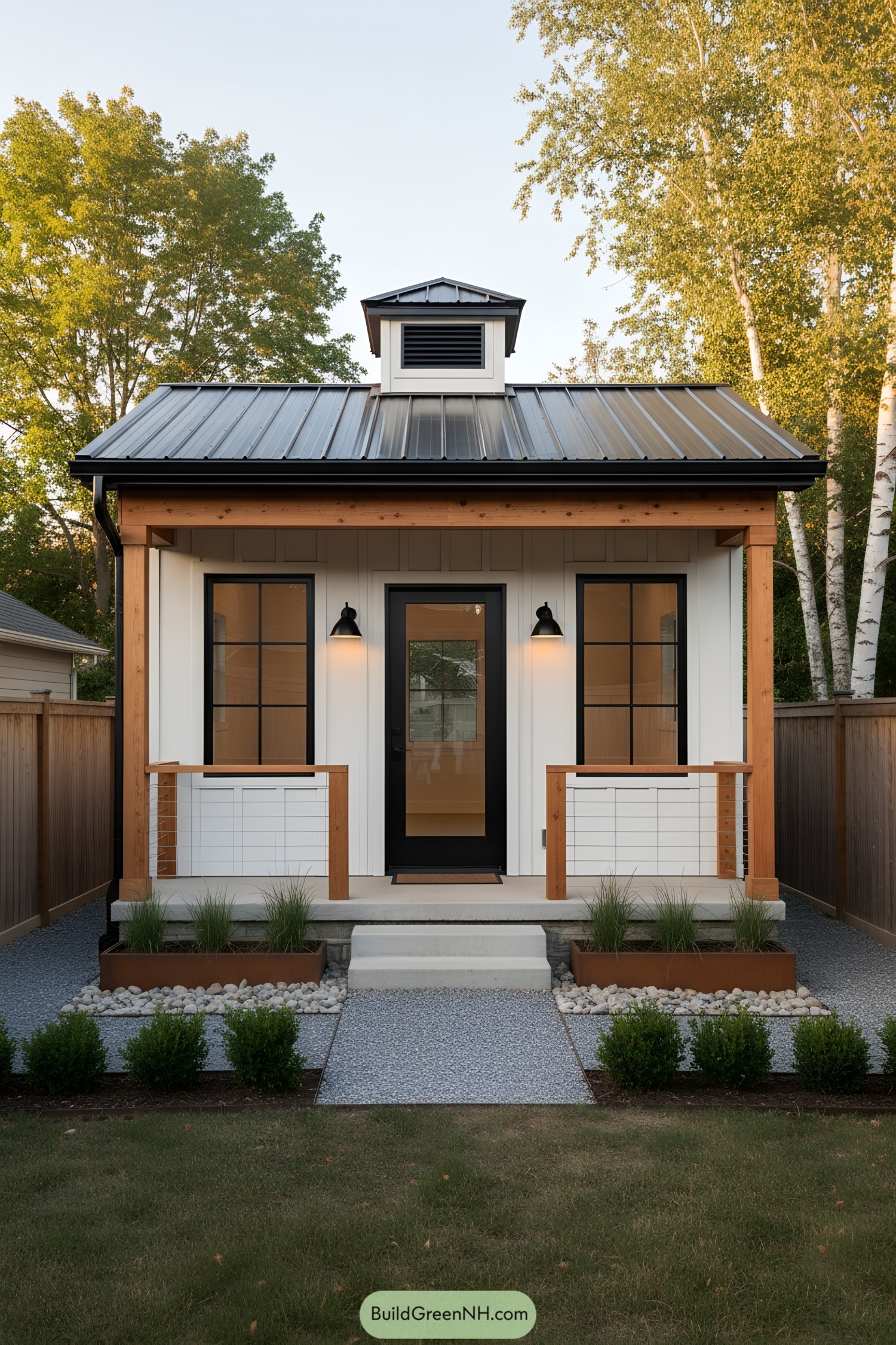 Small white craft shed with metal roof, black door, and wood-trimmed porch