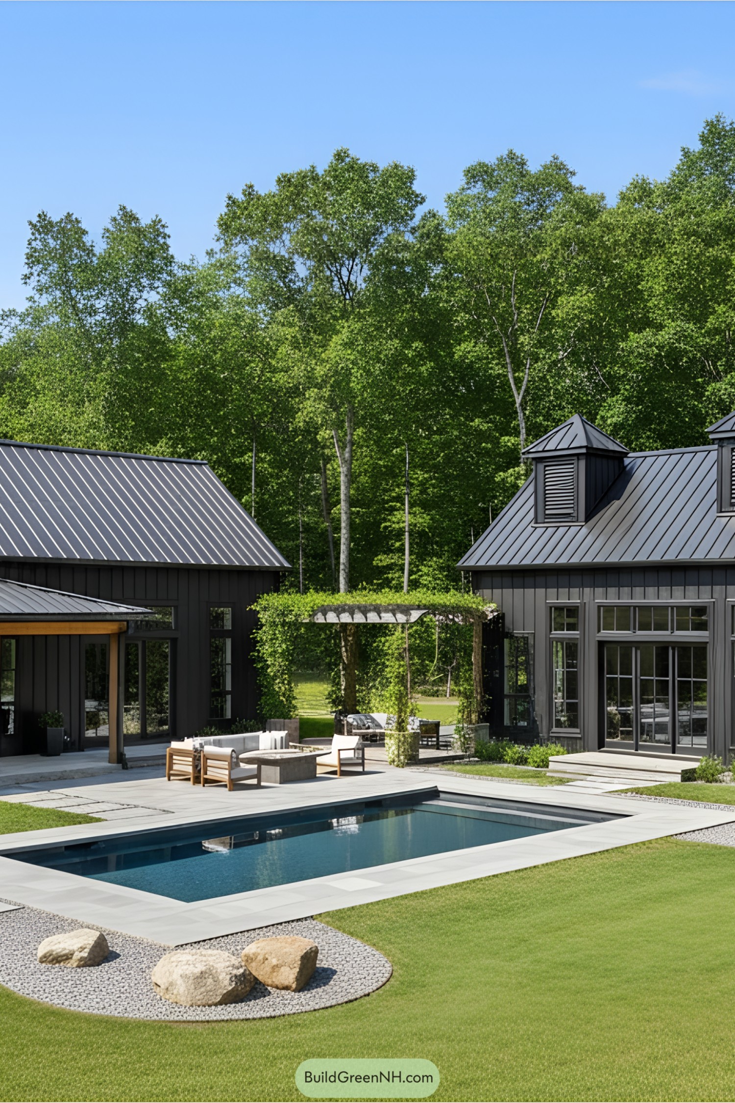 Modern barndominium with dark siding and pool