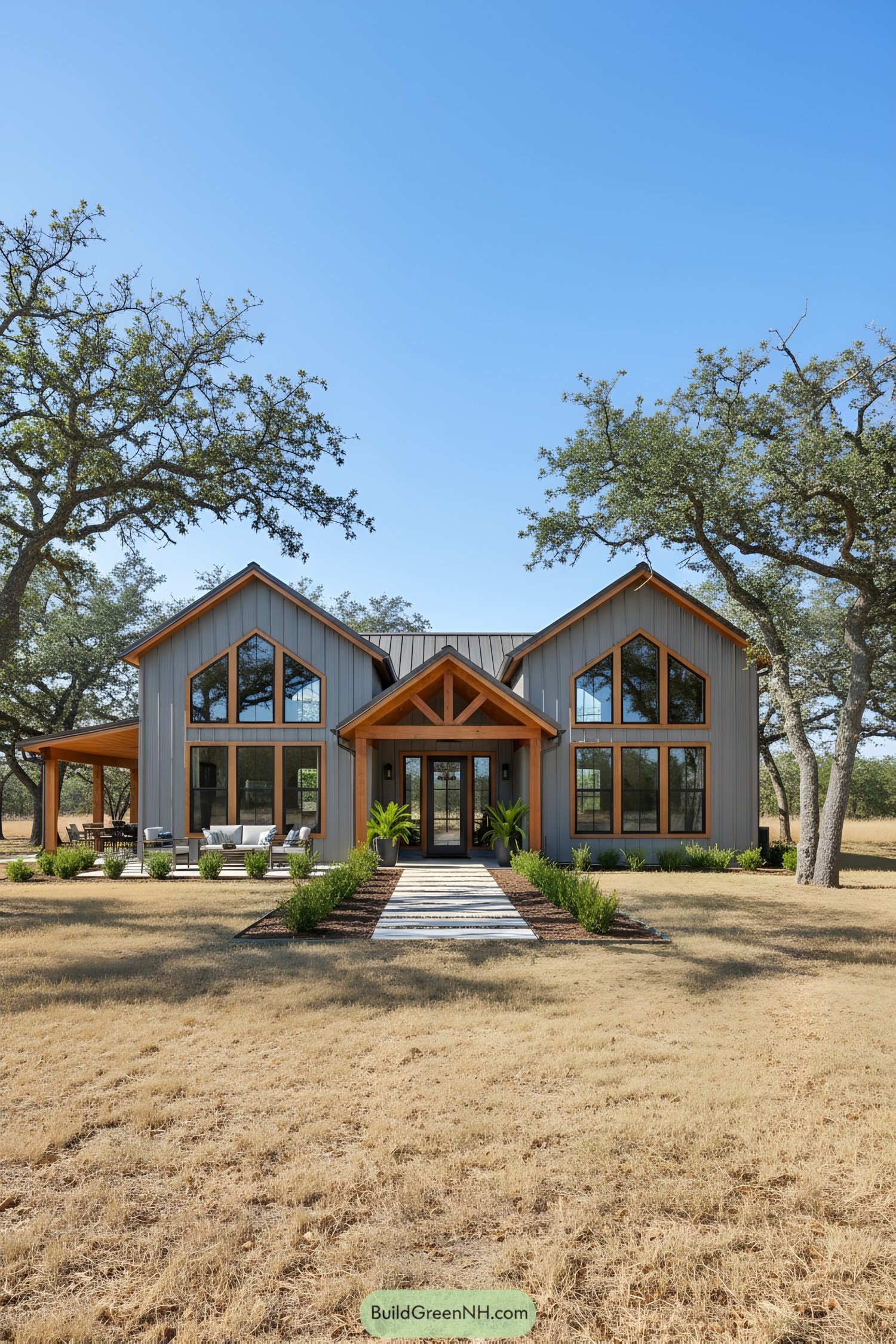 Modern barndominium with dual gables surrounded by trees