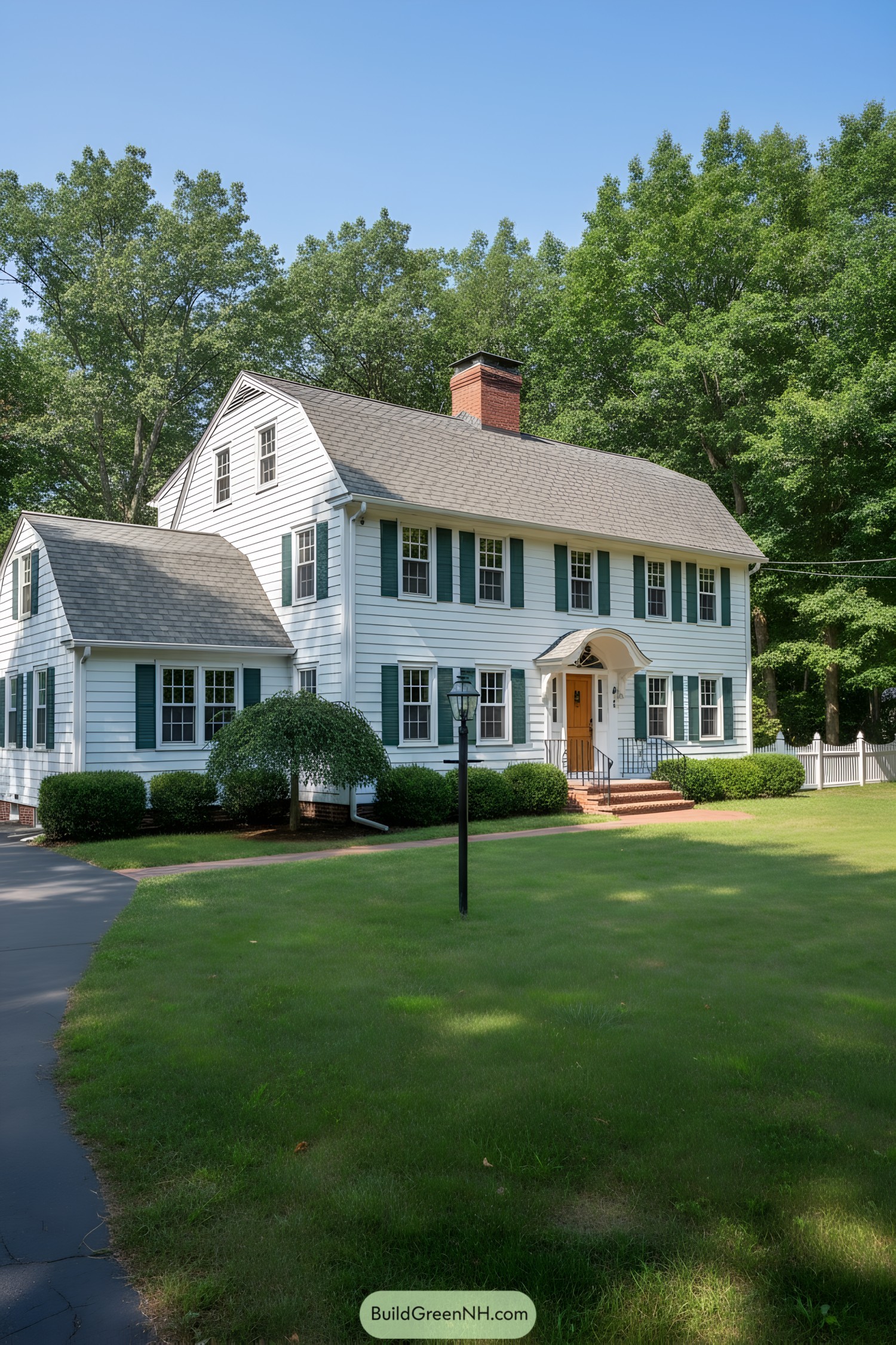 White clapboard gambrel colonial with green shutters