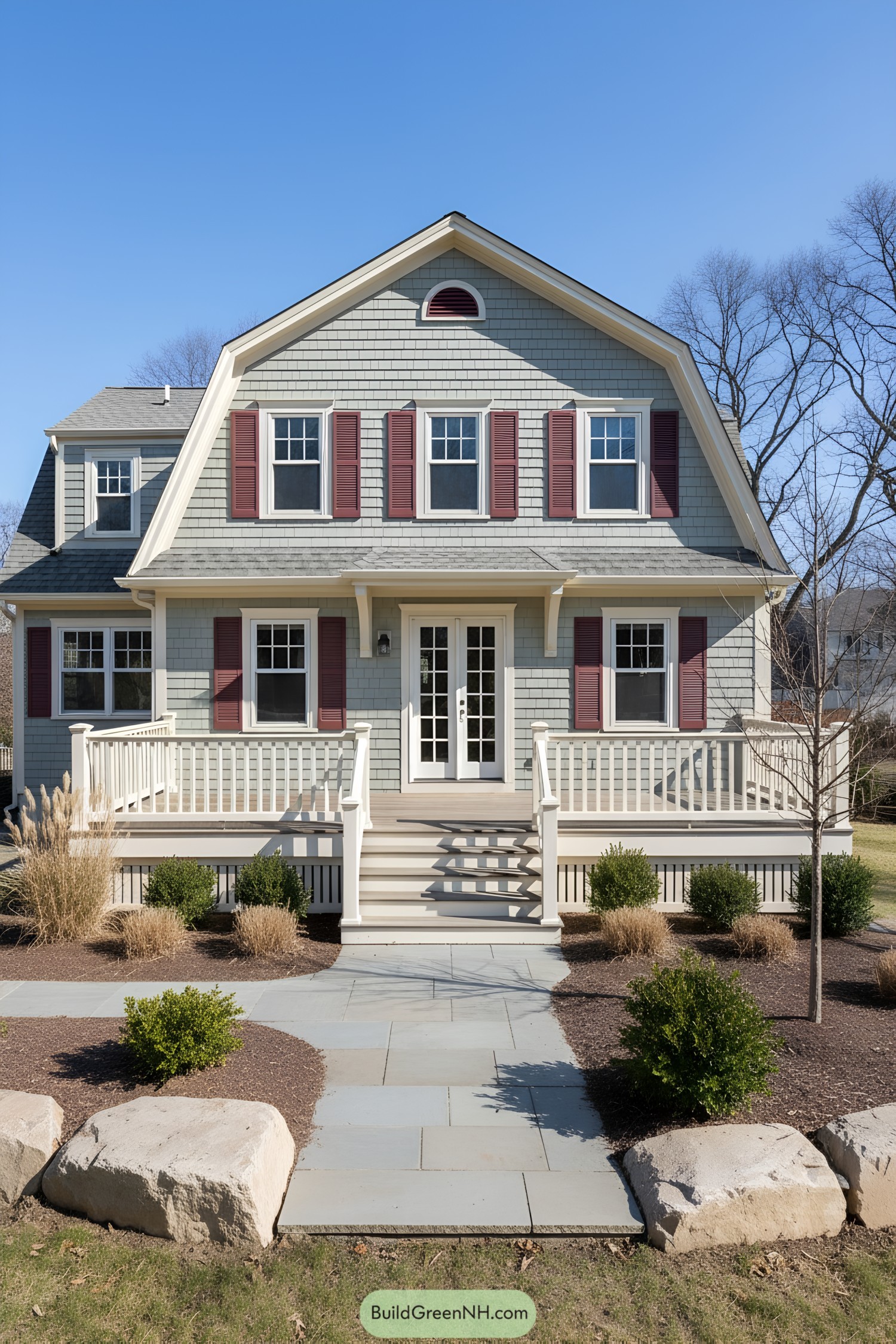 Light-gray shingle gambrel with plum shutters and wraparound porch