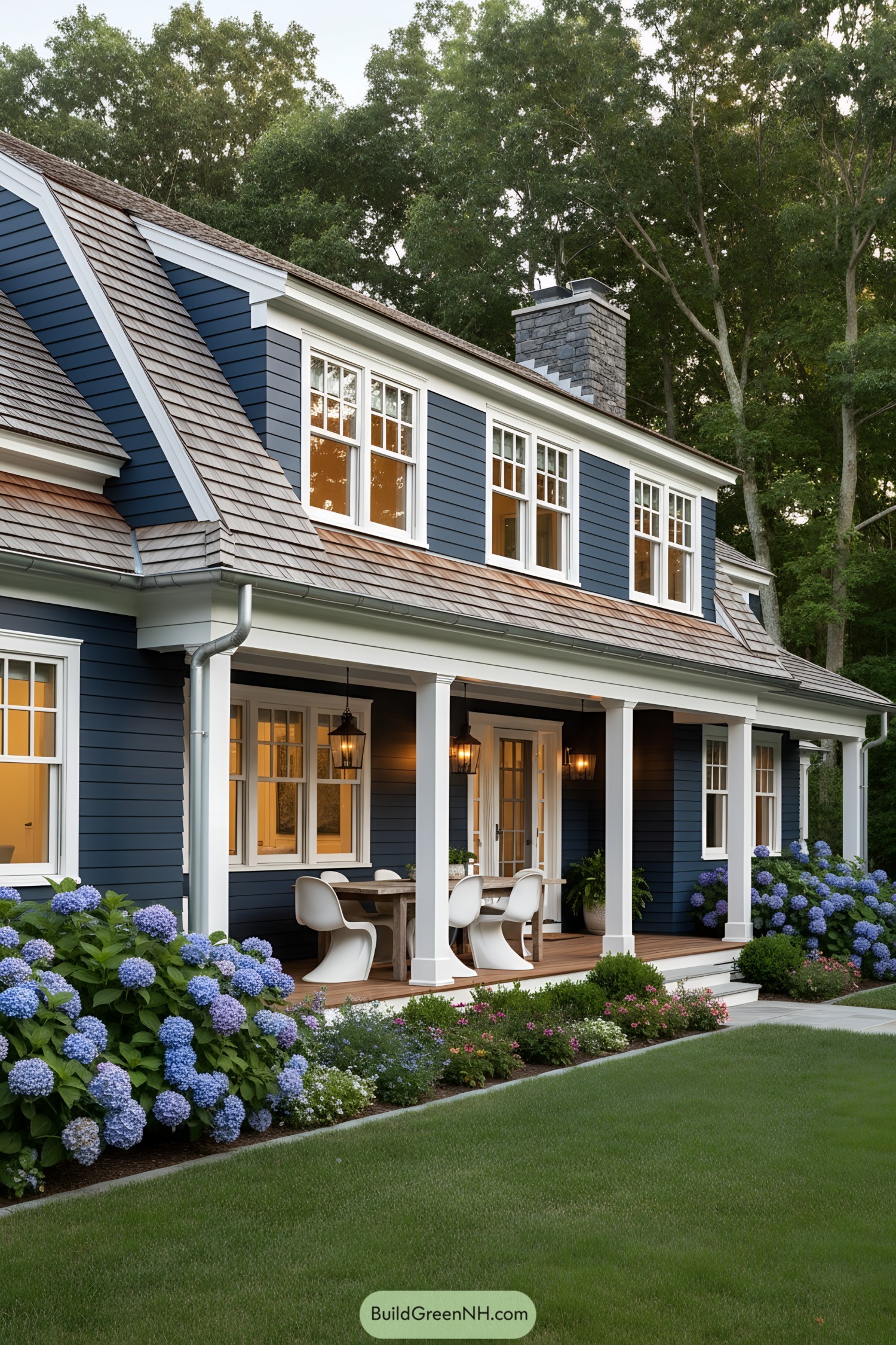 Blue clapboard gambrel with porch and hydrangeas