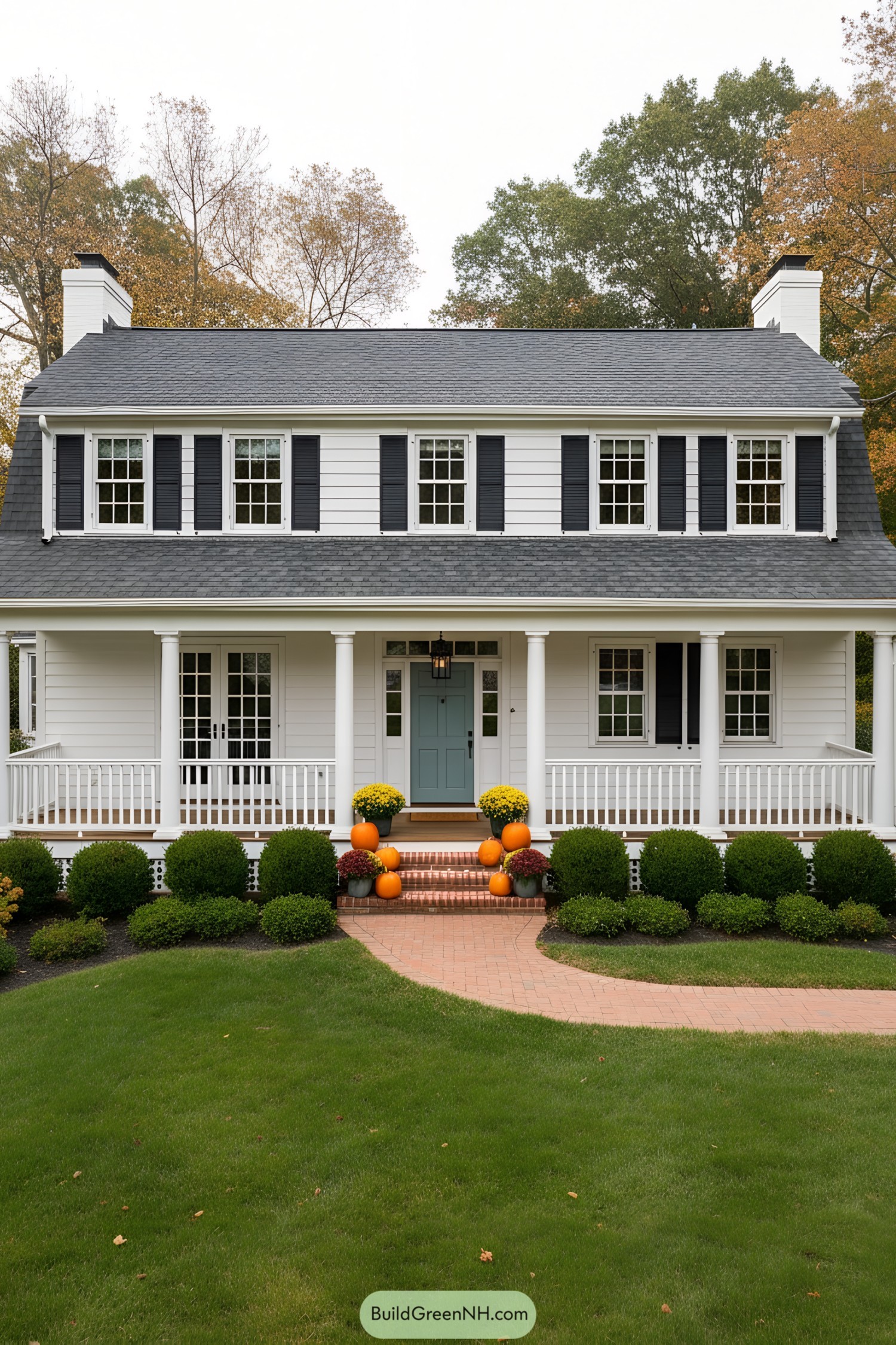 White gambrel colonial with wraparound porch and blue door