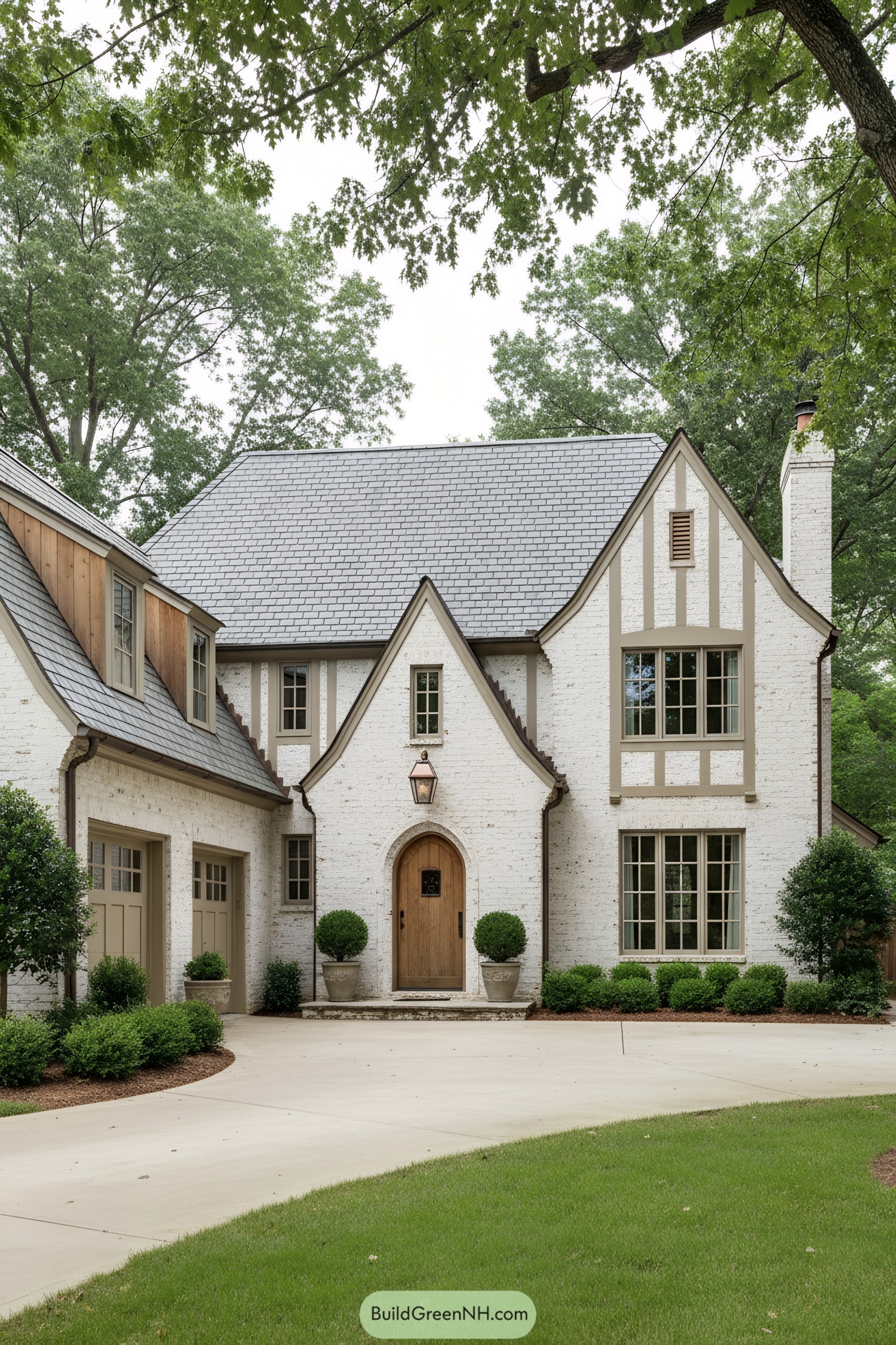 White-brick French Tudor with steep gables