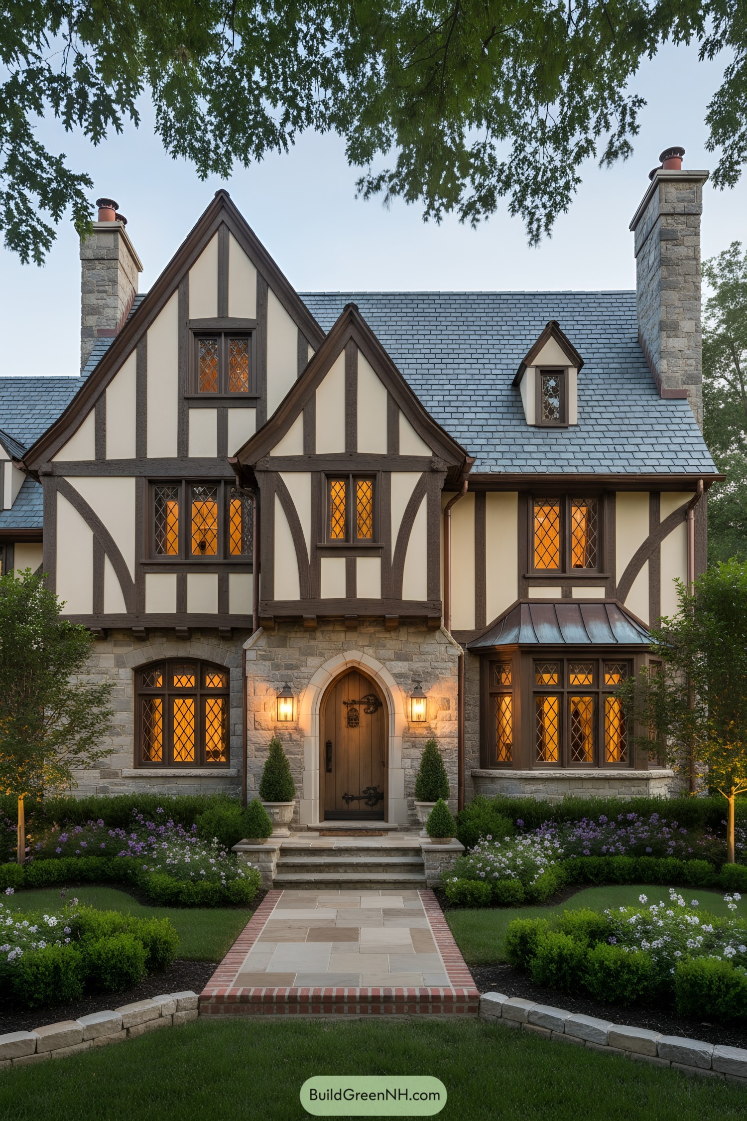 French Tudor house with steep gables, timbering, stone base, and leaded windows