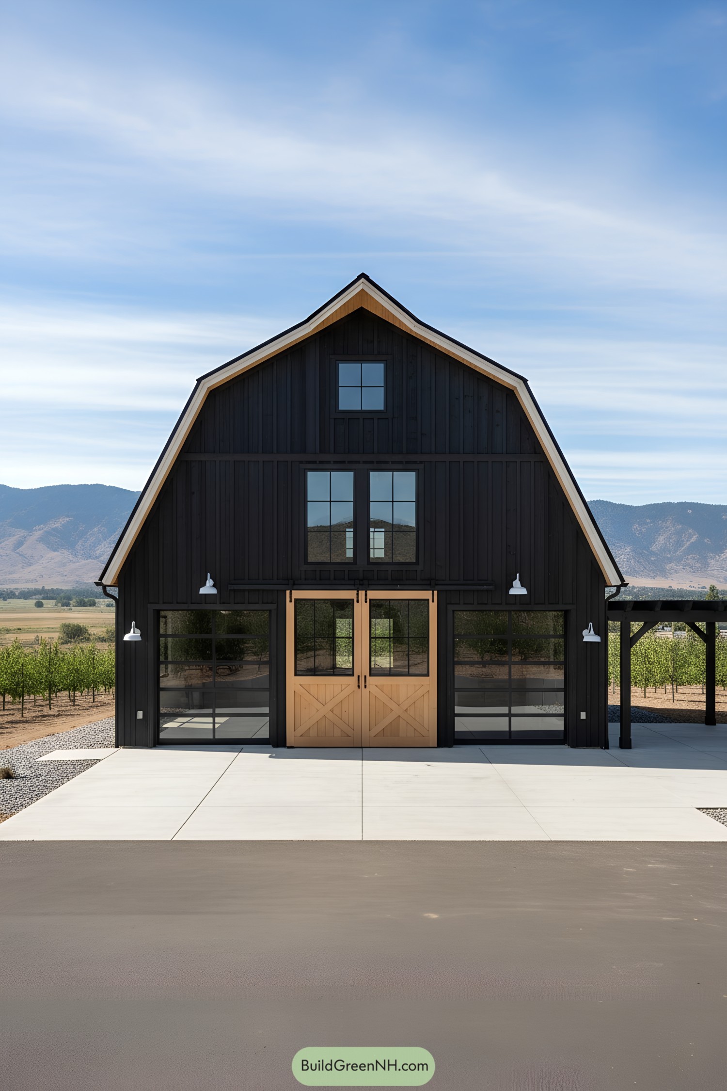 Black gambrel barn with wood doors and glass bays