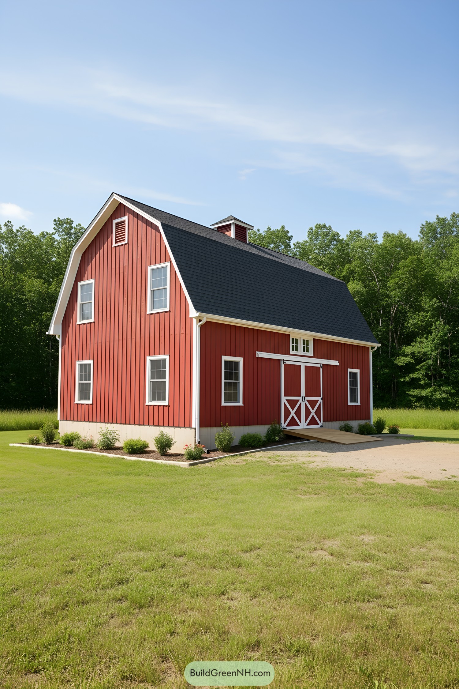 Red gambrel barn with white trim and cupola
