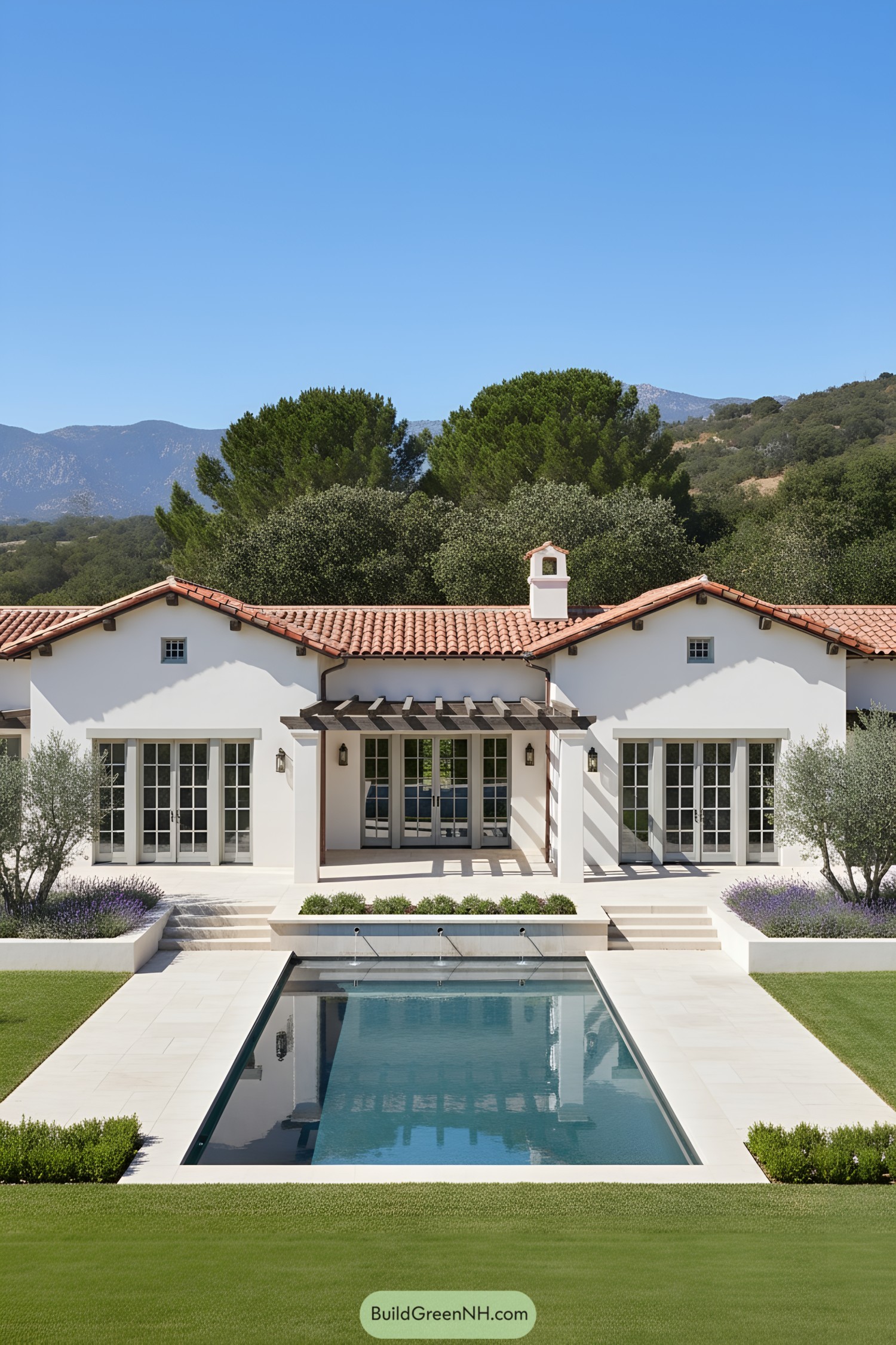White stucco farmhouse with red-tile roof, pergola porch, French doors, and linear pool