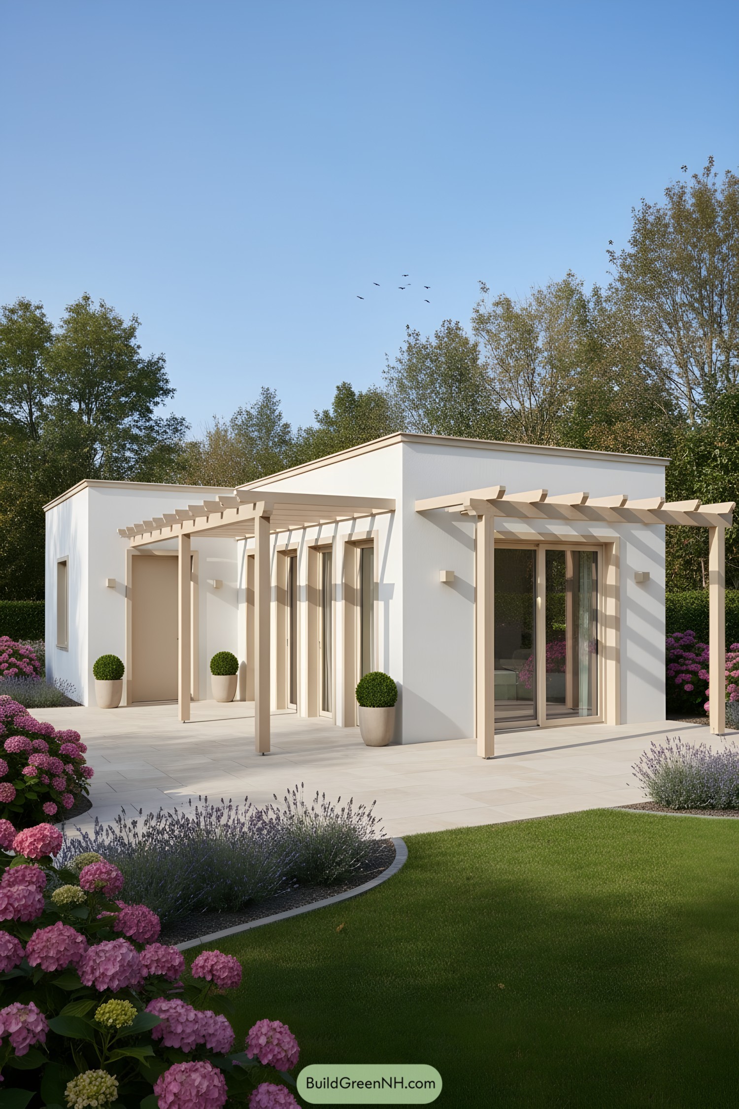 Modern white stucco tiny house with beige pergolas and large glass doors, set in a landscaped garden