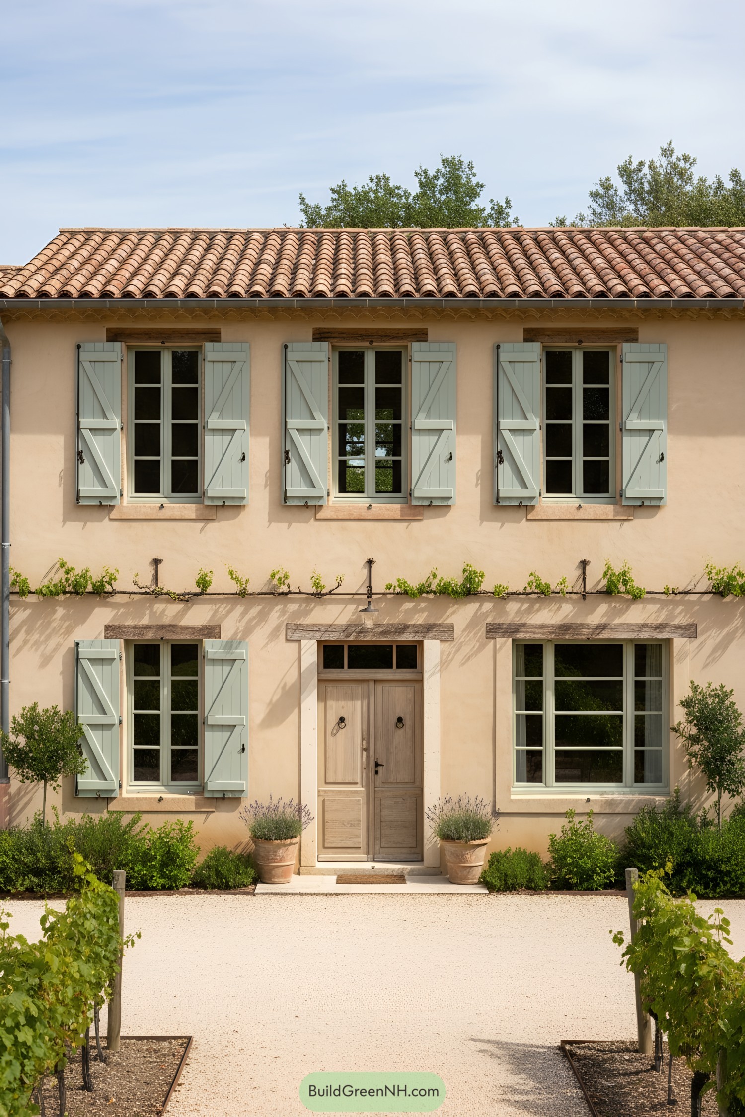 Beige stucco townhouse with mint shutters and terracotta roof