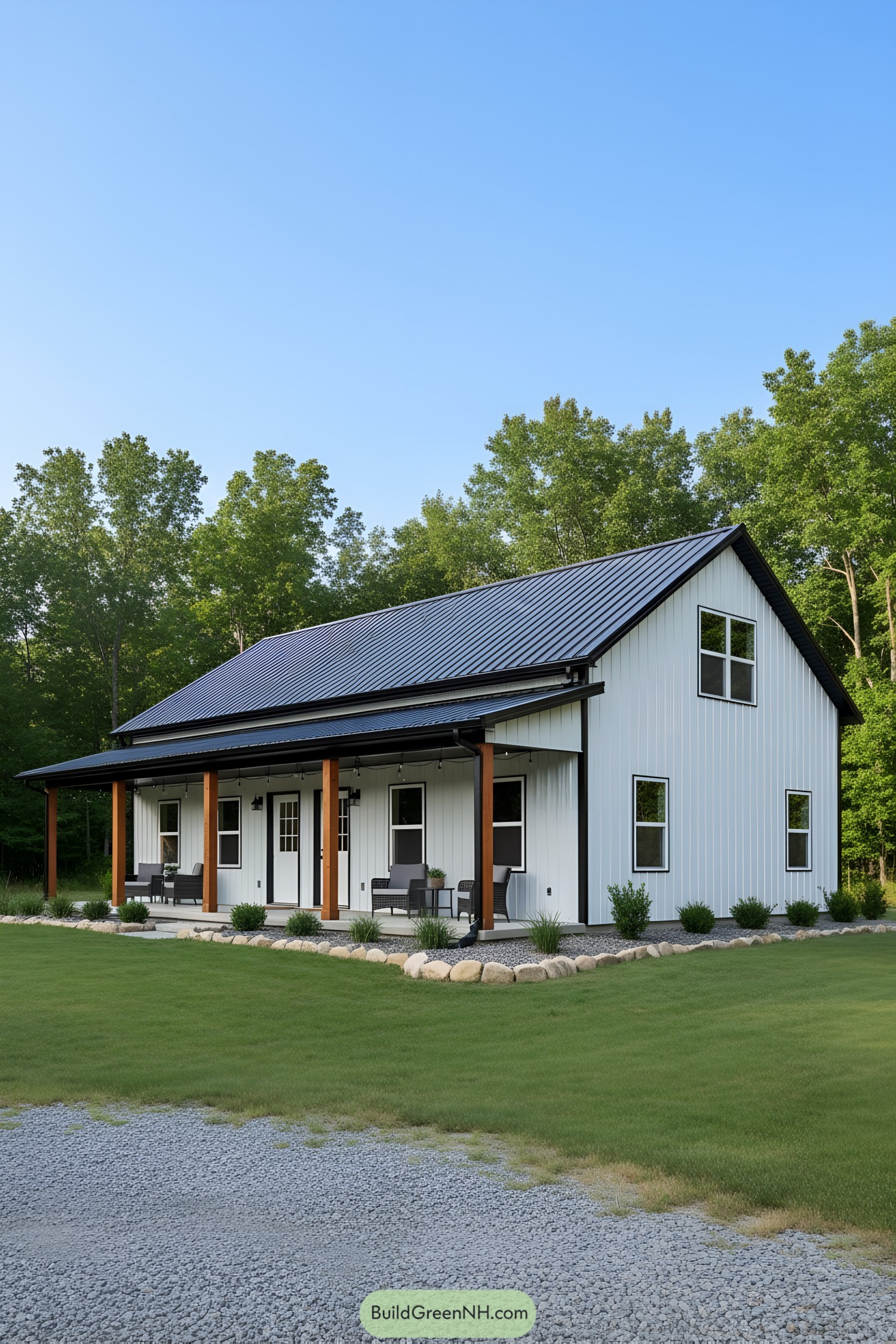 White metal barndominium with black roof and porch
