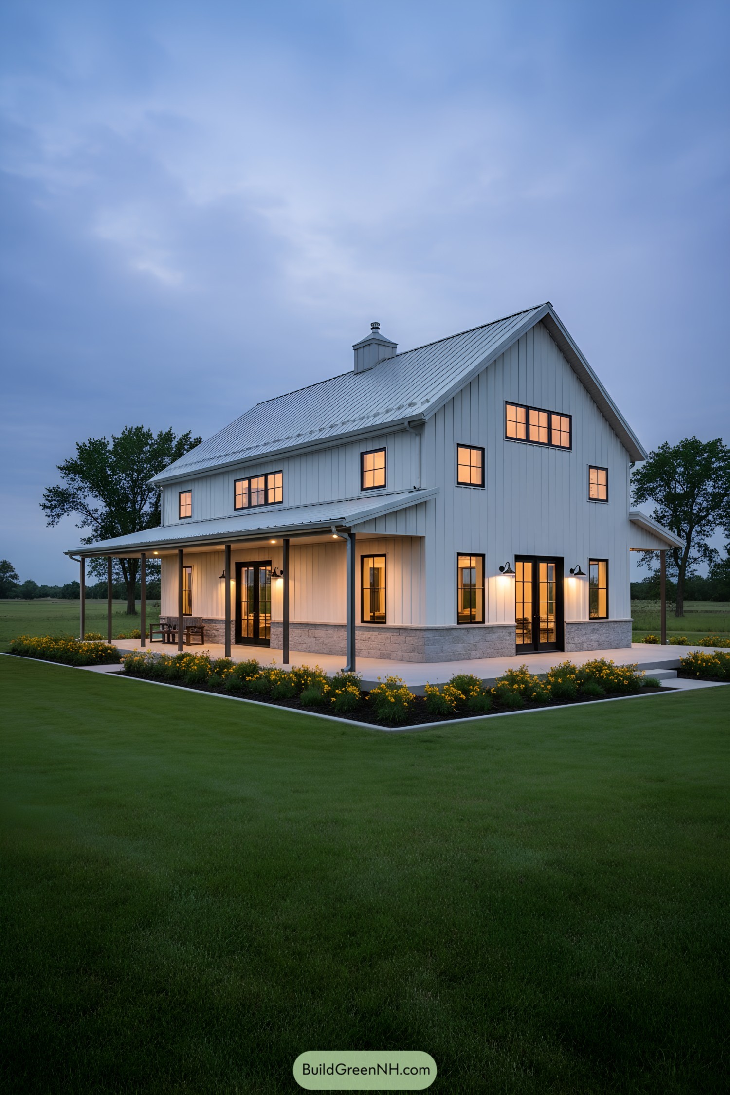 White board-and-batten barndo with wraparound porch at dusk