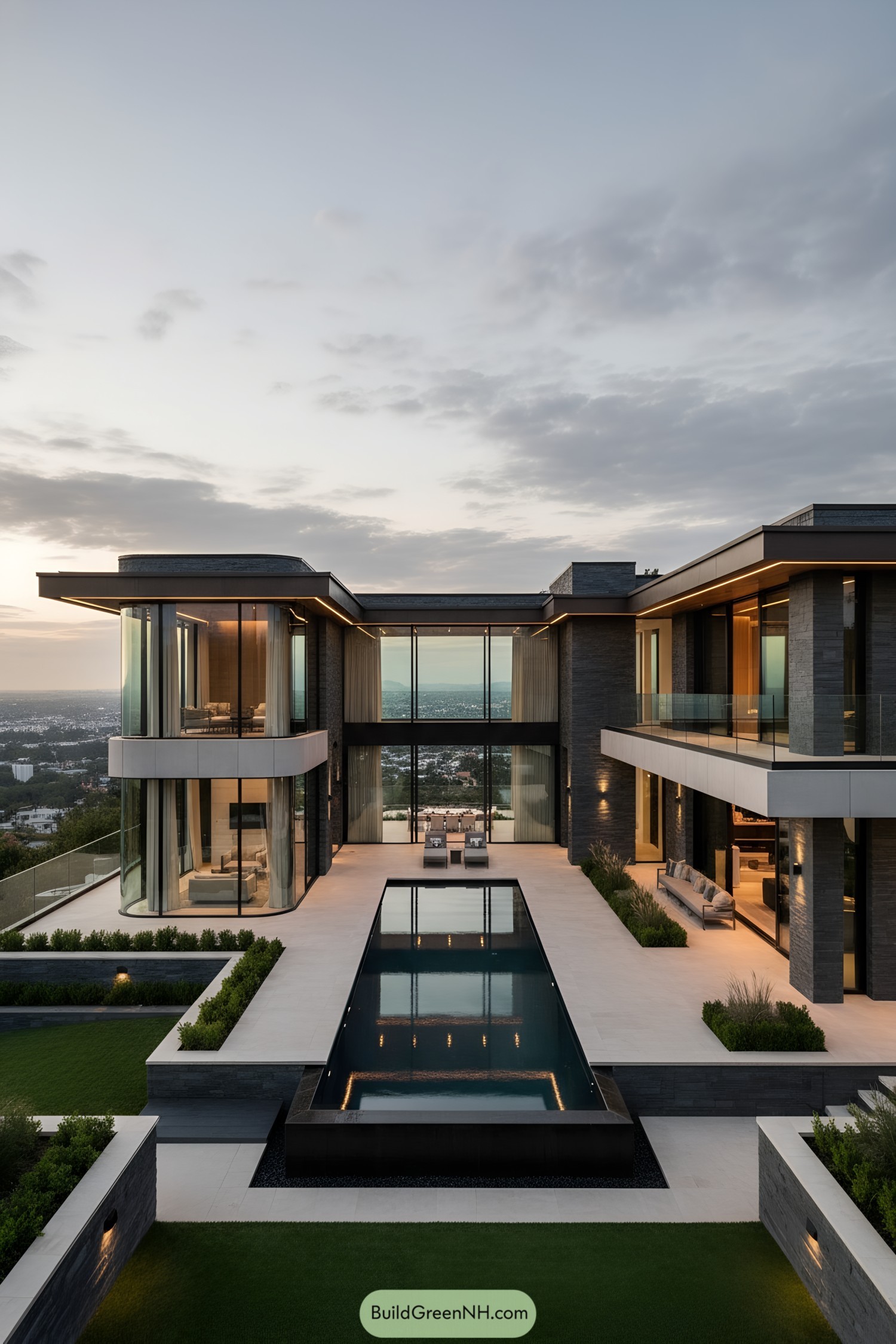 Modern hillside mansion with central reflecting pool and glass-walled wings at dusk