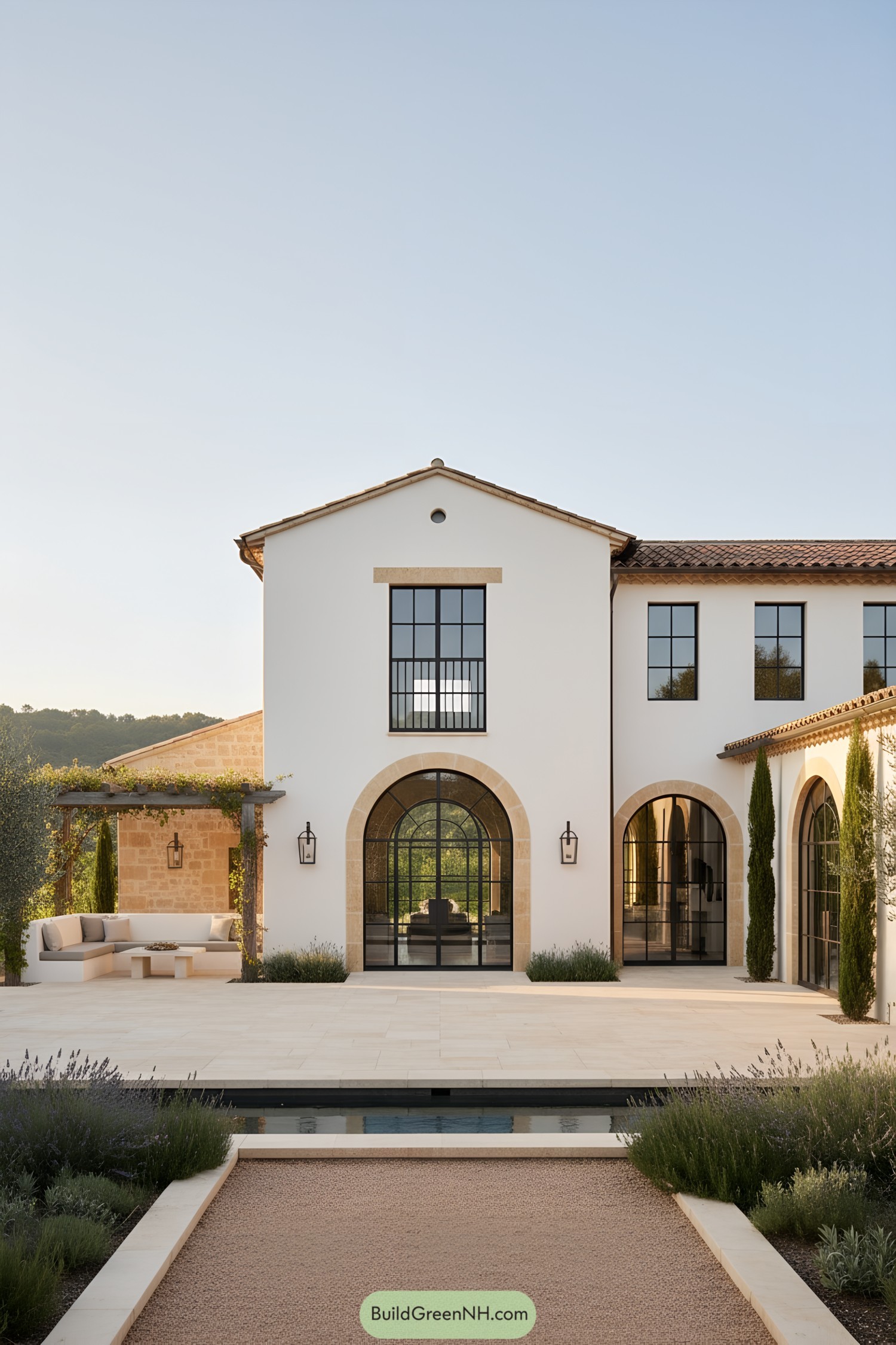 White stucco farmhouse with arched steel windows