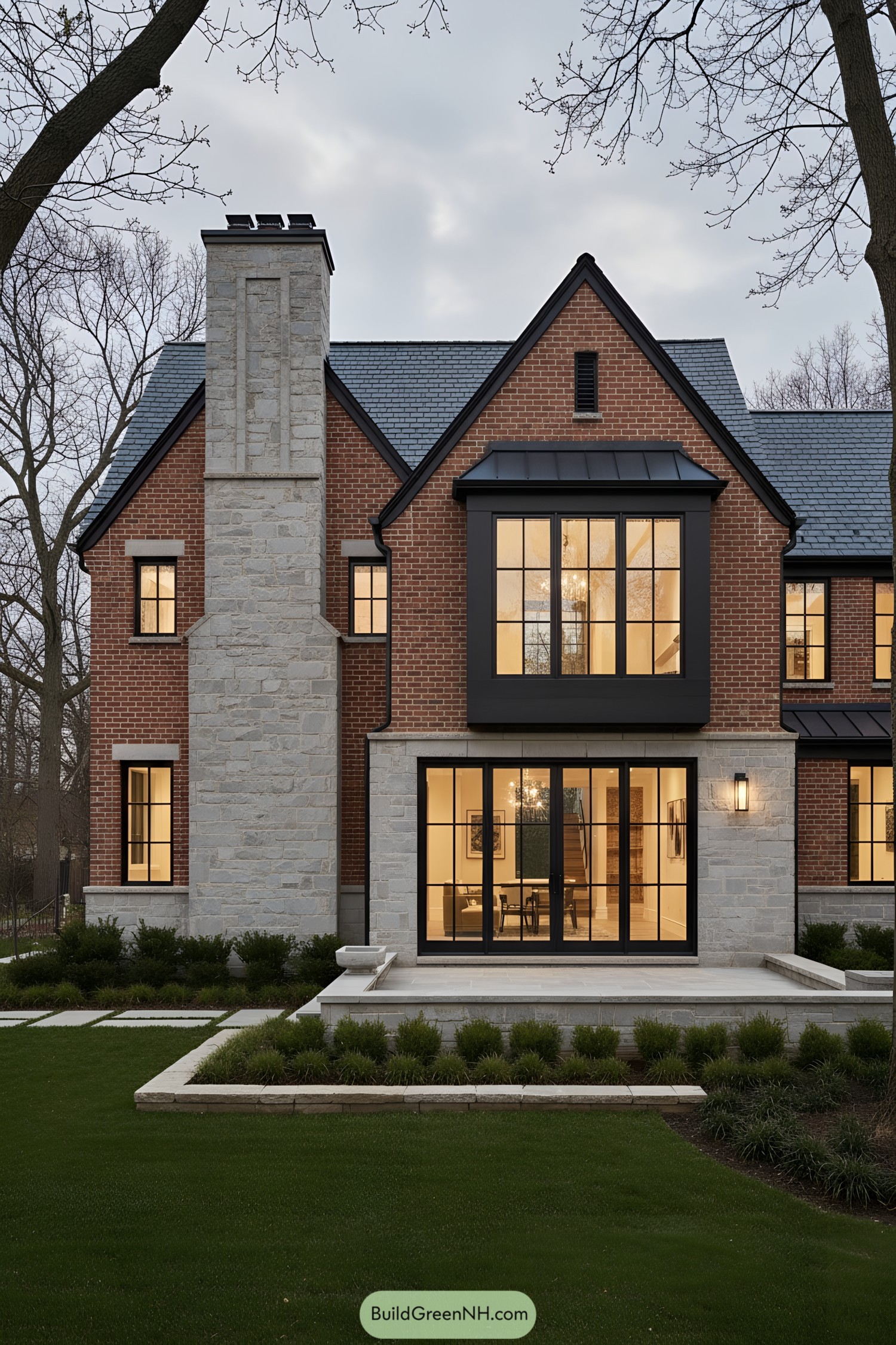 Red-brick gabled house with stone chimney and black-framed windows