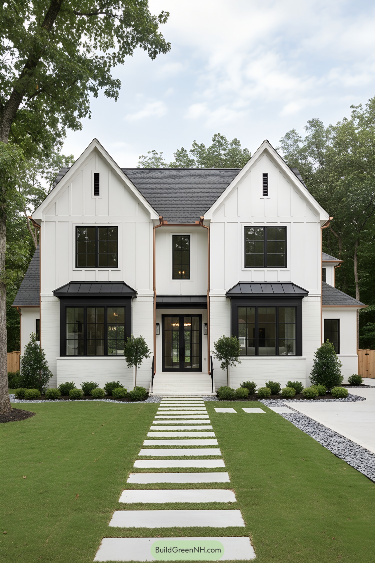 White modern Tudor with black windows, copper gutters, twin gables, central glass door, stepping-stone path