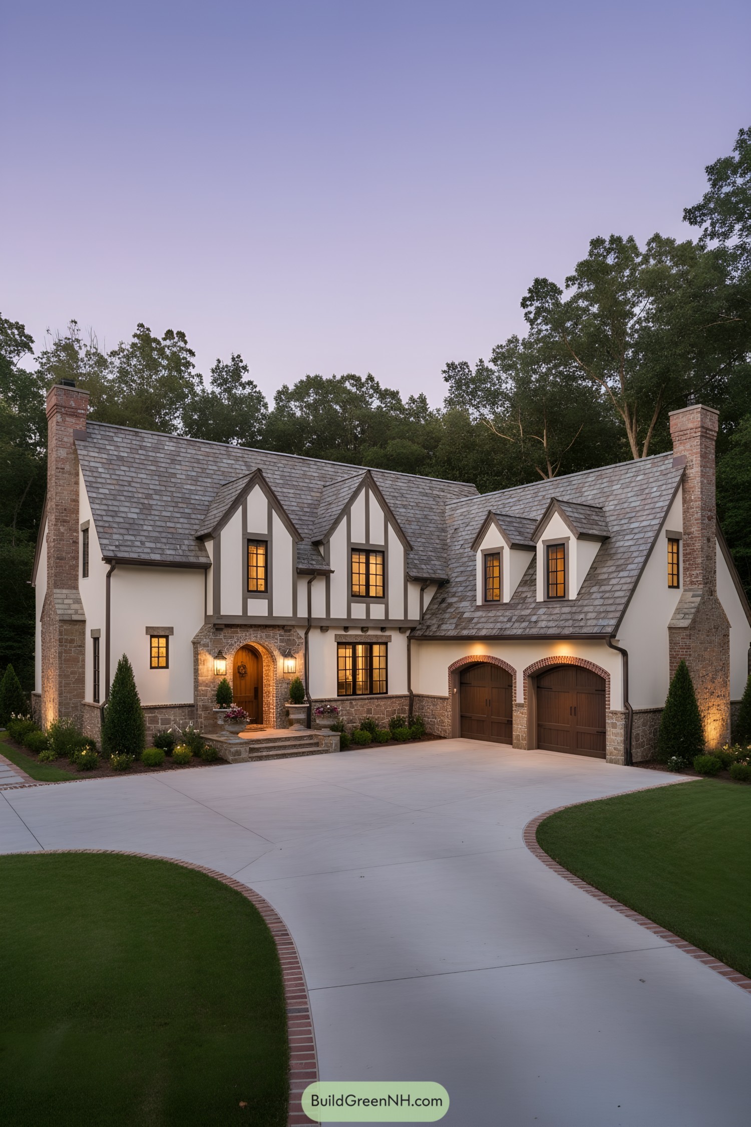 Modern Tudor mansion with slate roof, timber trim, and arched garage doors