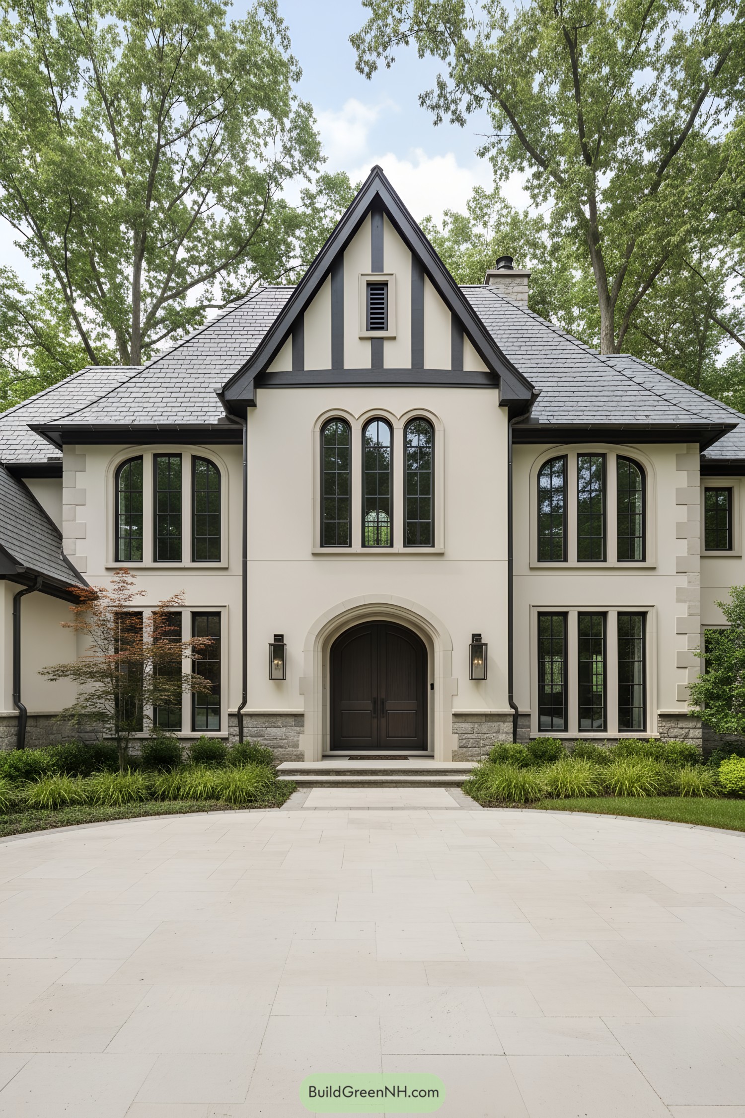 Cream stucco manor with dark trim and arched entry