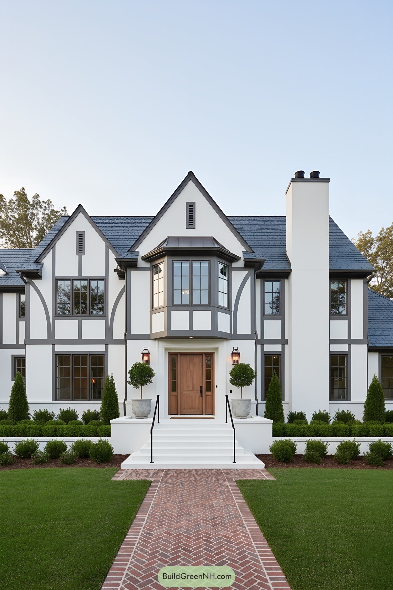 Modern Tudor facade with gray half-timbering, bay window, and warm wood door