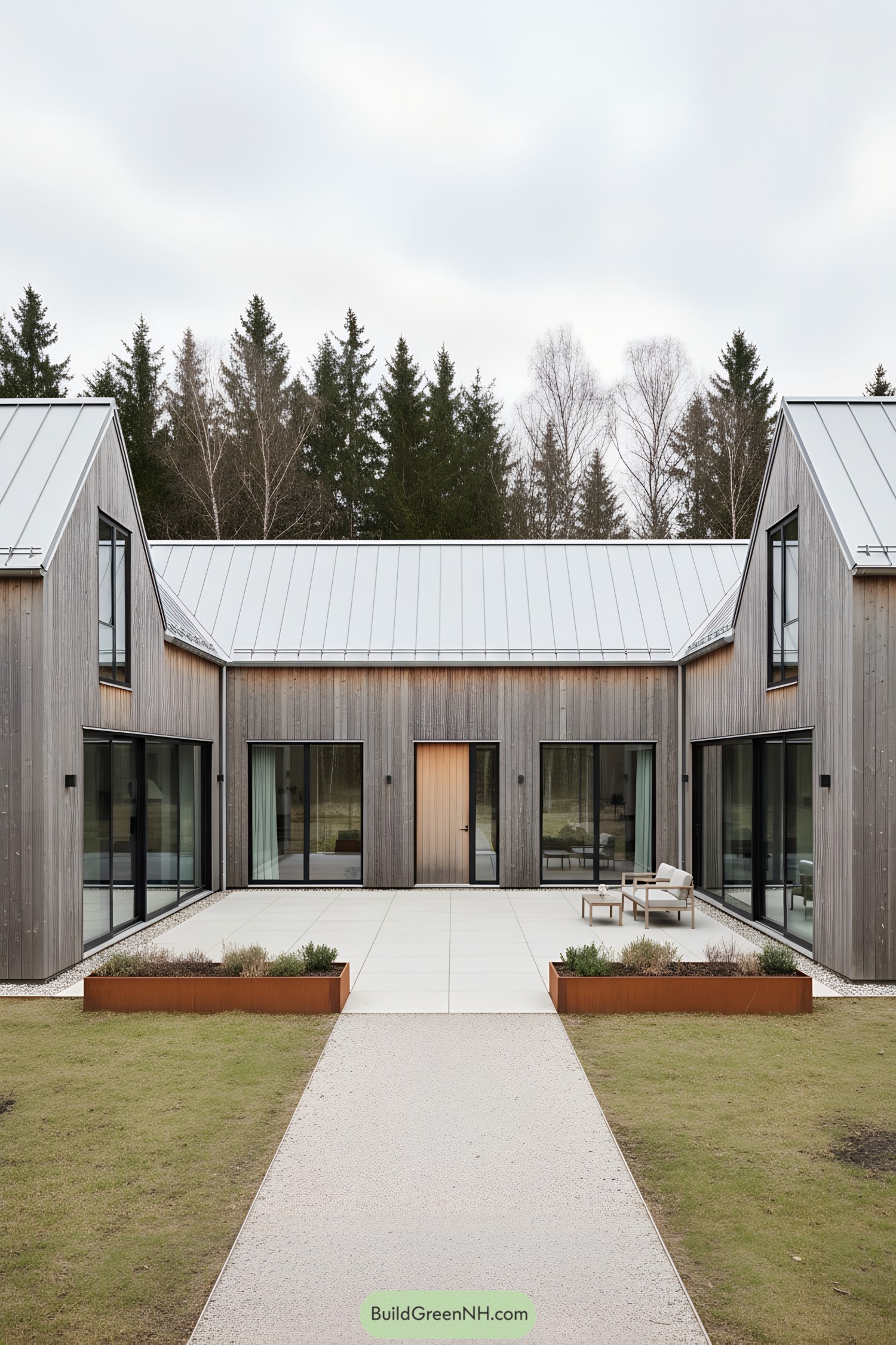 Modern barn-style courtyard with gray timber cladding and metal gable roofs