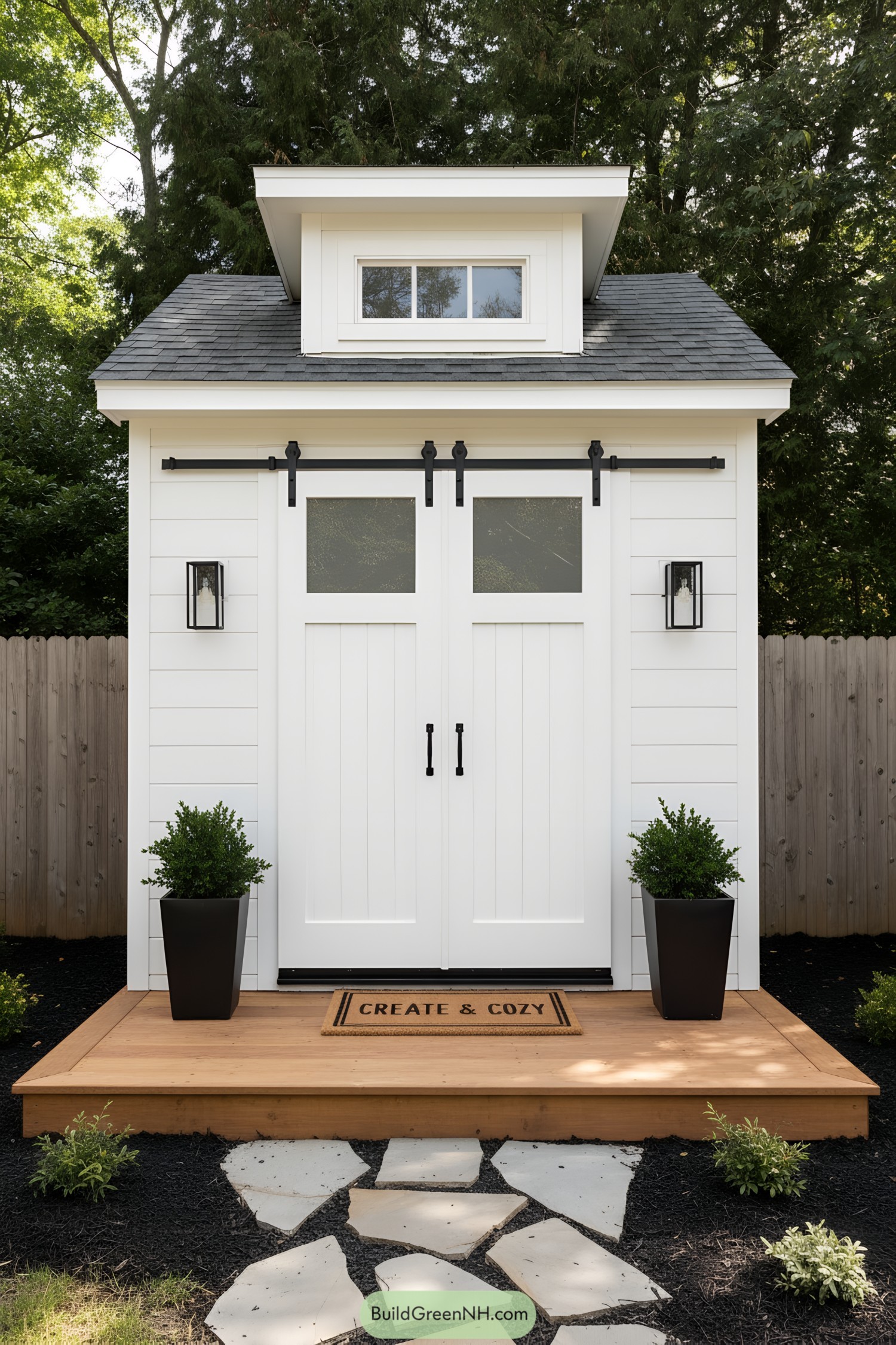 White studio shed with black hardware and dormer