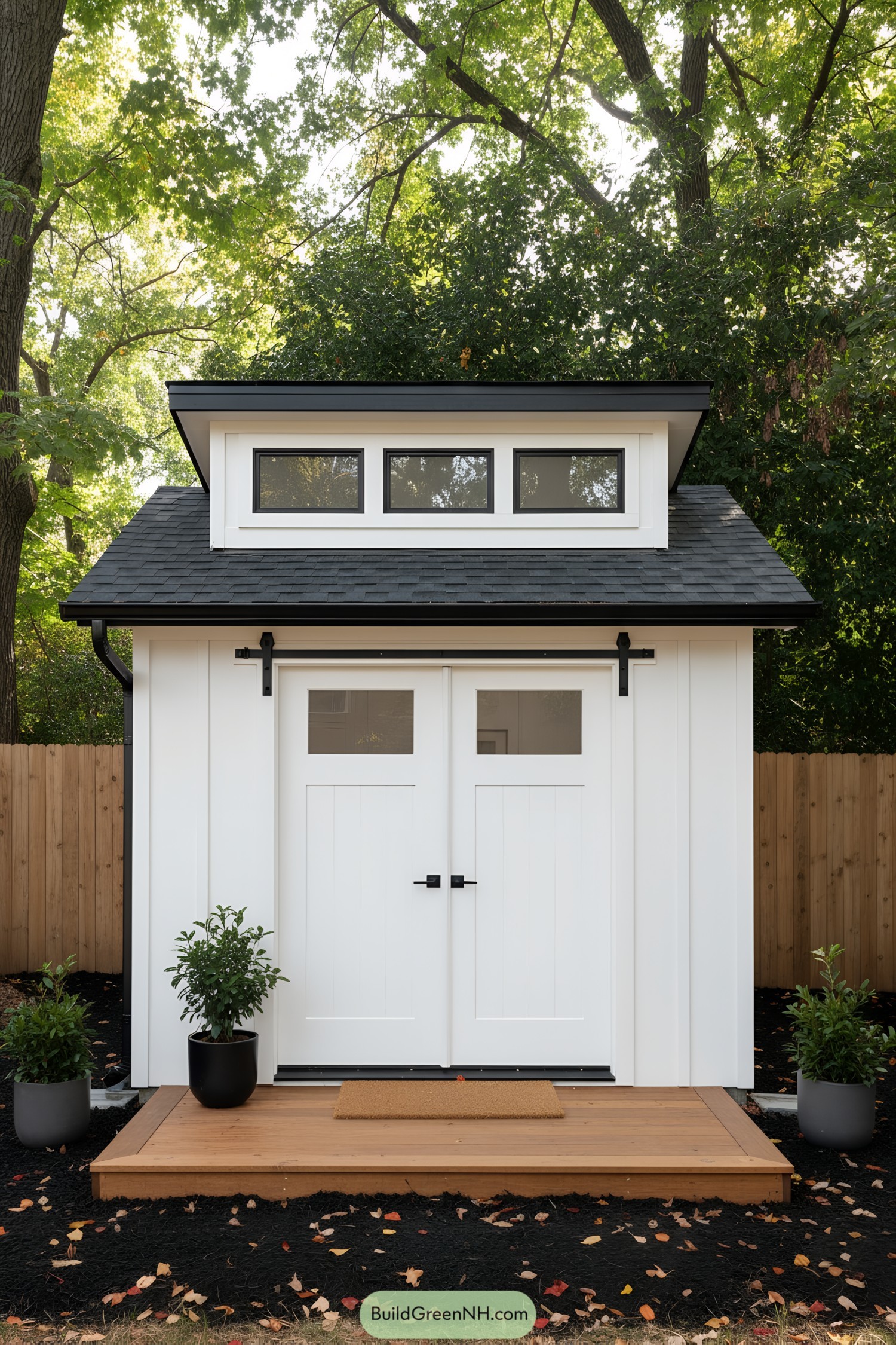 Small white shed with clerestory windows and black trim