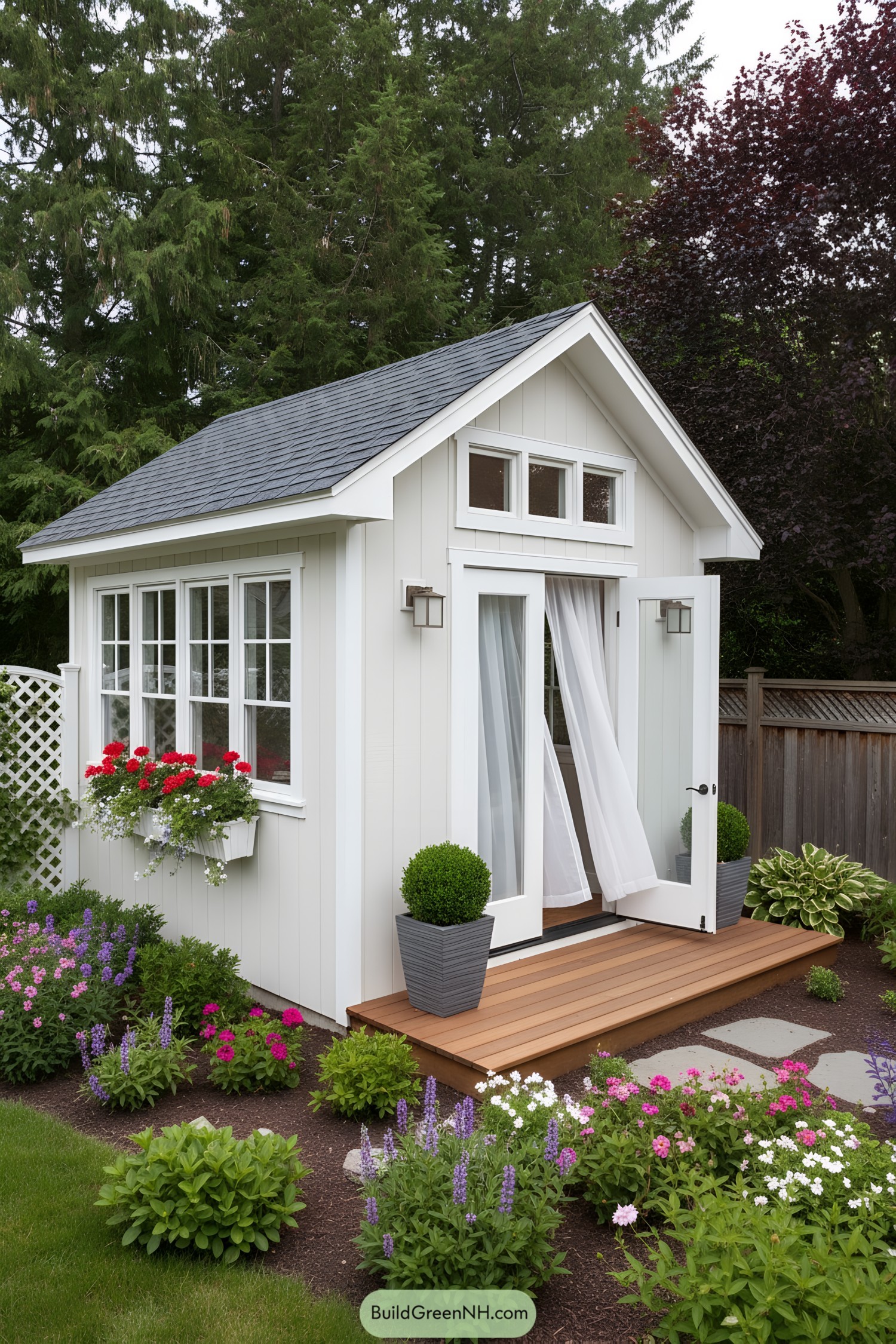 Small gable-roof shed with French doors and side windows amid flowers