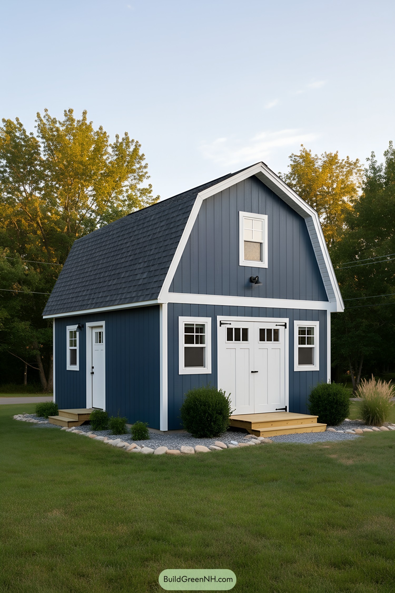 Blue gambrel-roof shed with white trim and loft windows