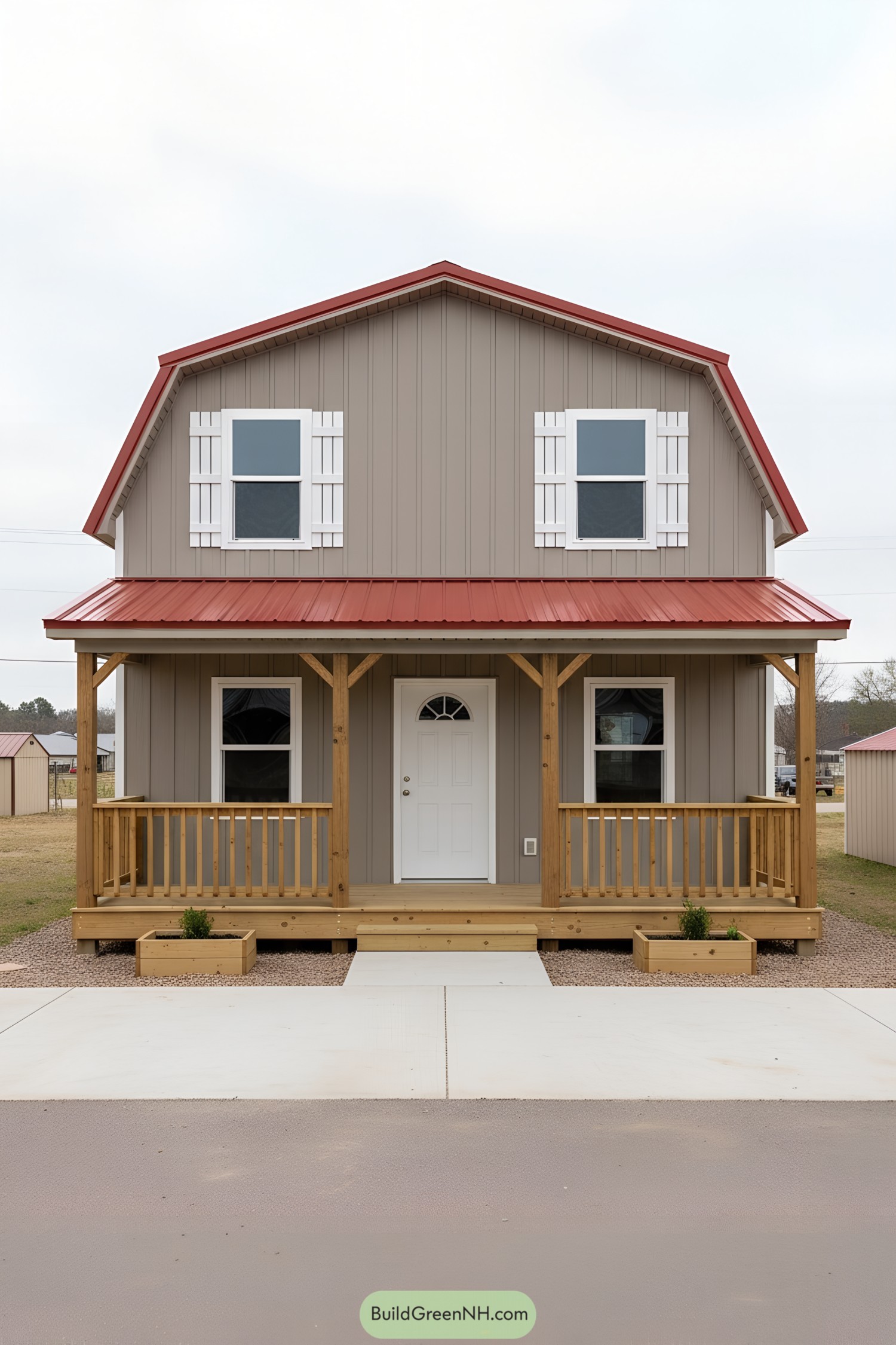 Small barn-style shed home with red metal roof and front porch
