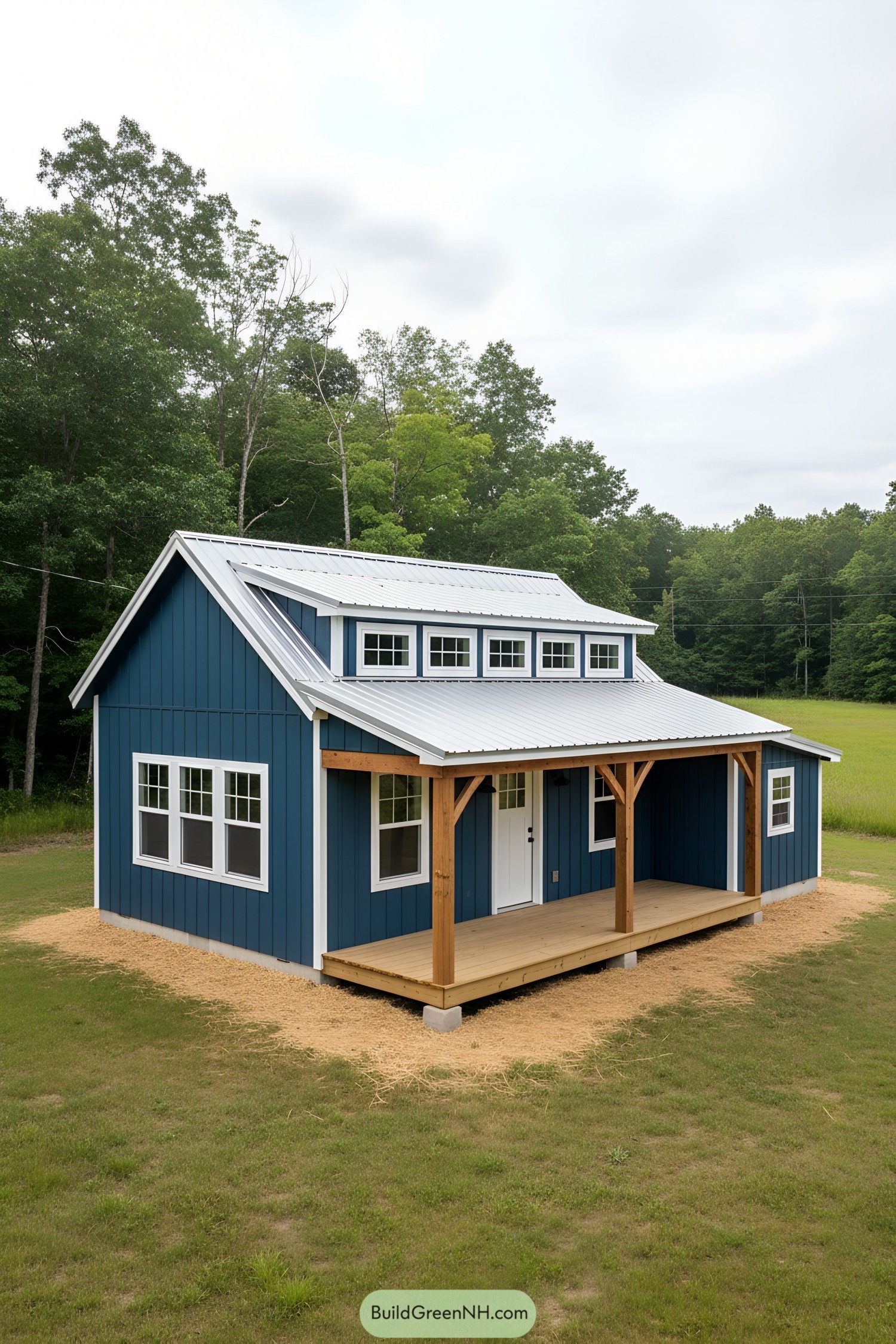 Blue shed home with porch and dormer