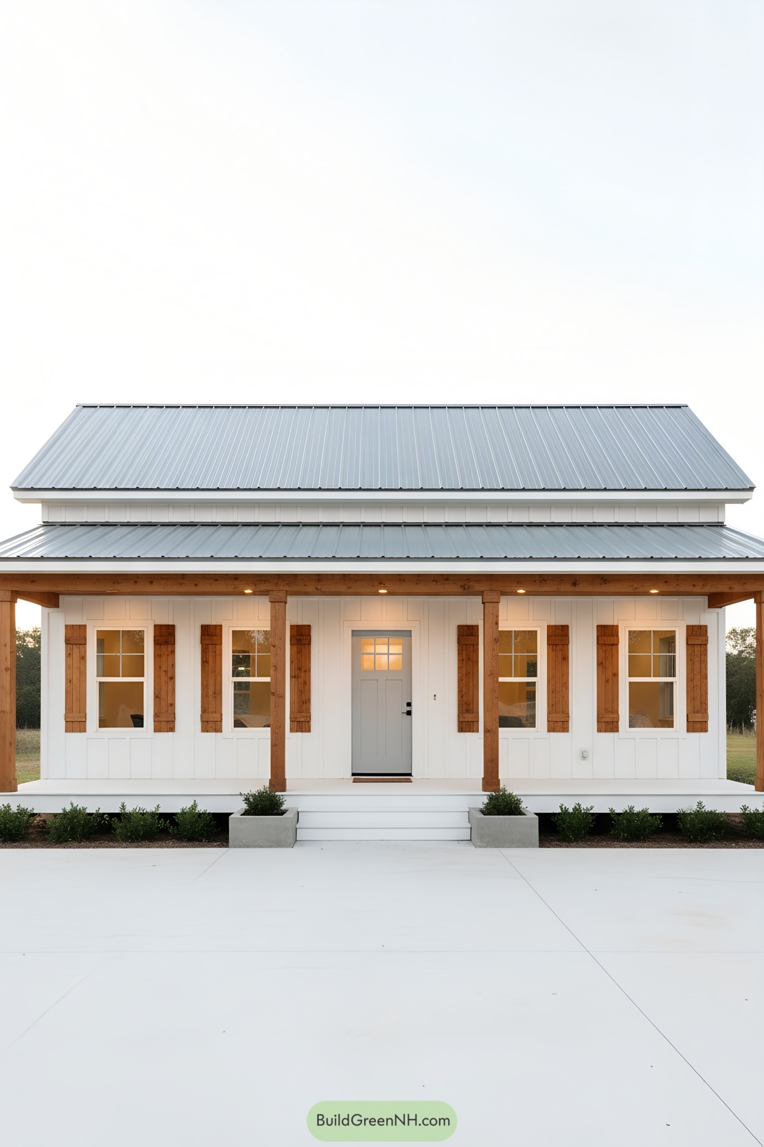 White cottage with metal roof and timber porch
