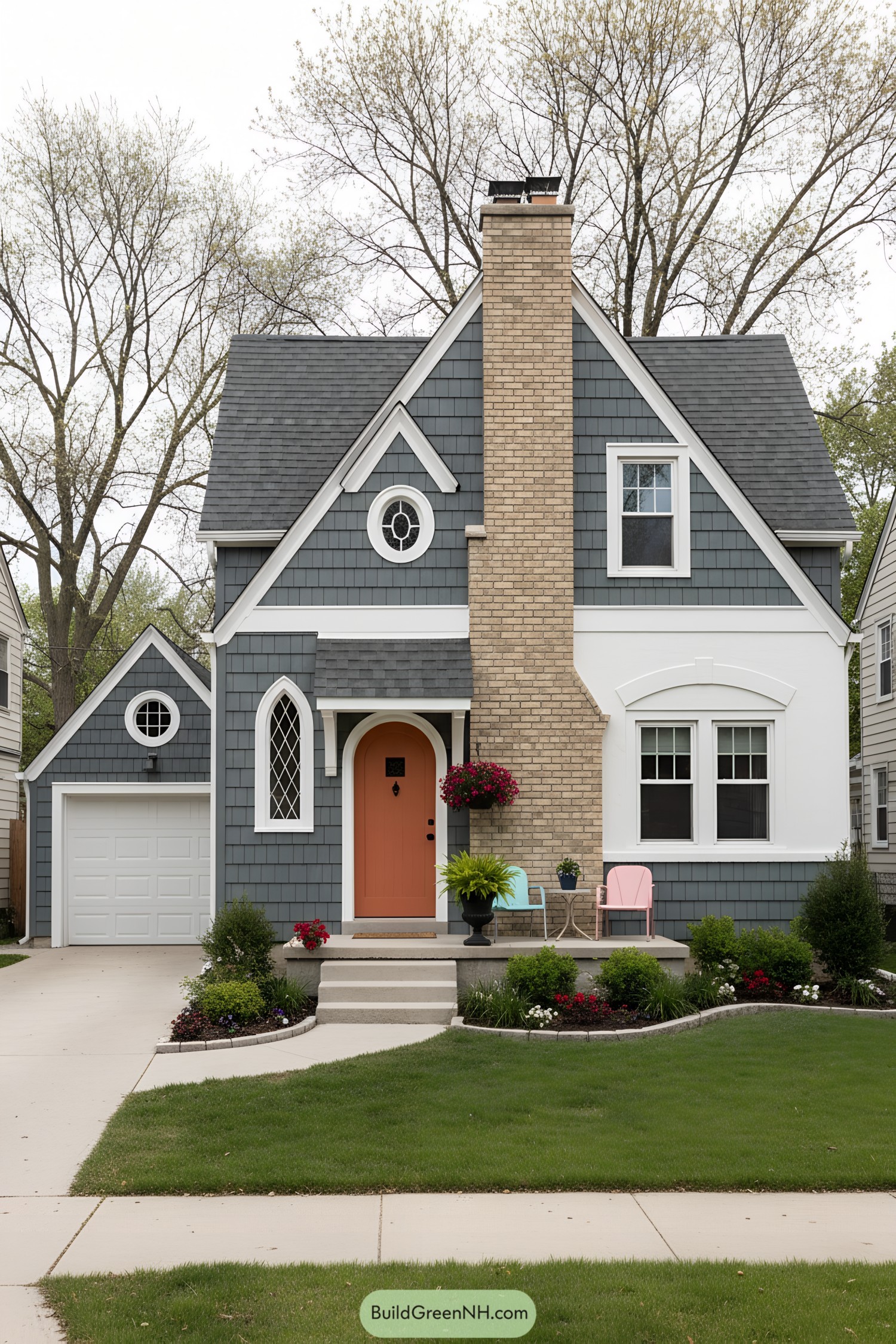 Compact Tudor cottage with coral door, brick chimney, and gray shingle siding
