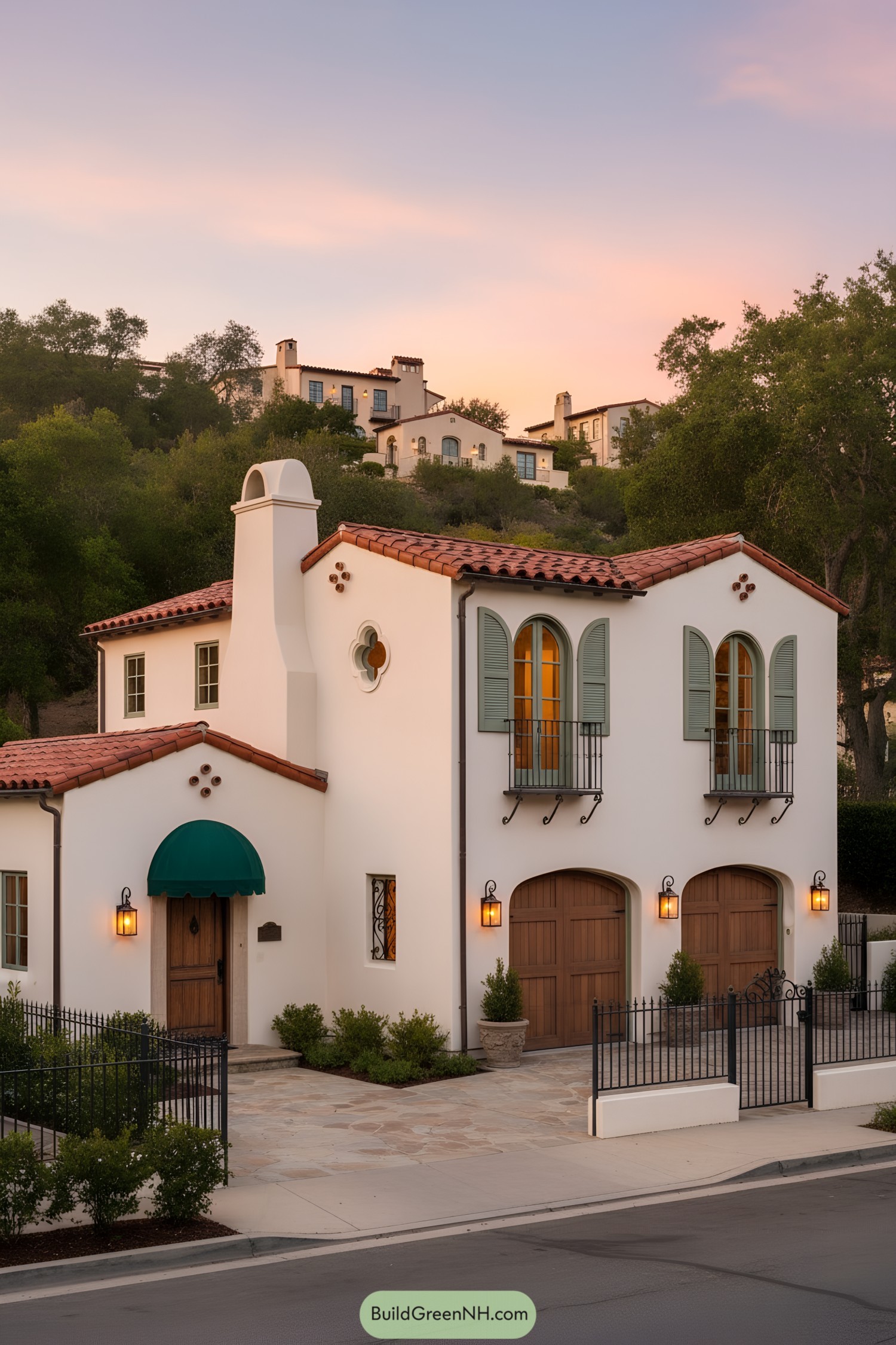 Two-story Spanish Colonial home with arched shutters, terracotta roof, and wooden garage doors